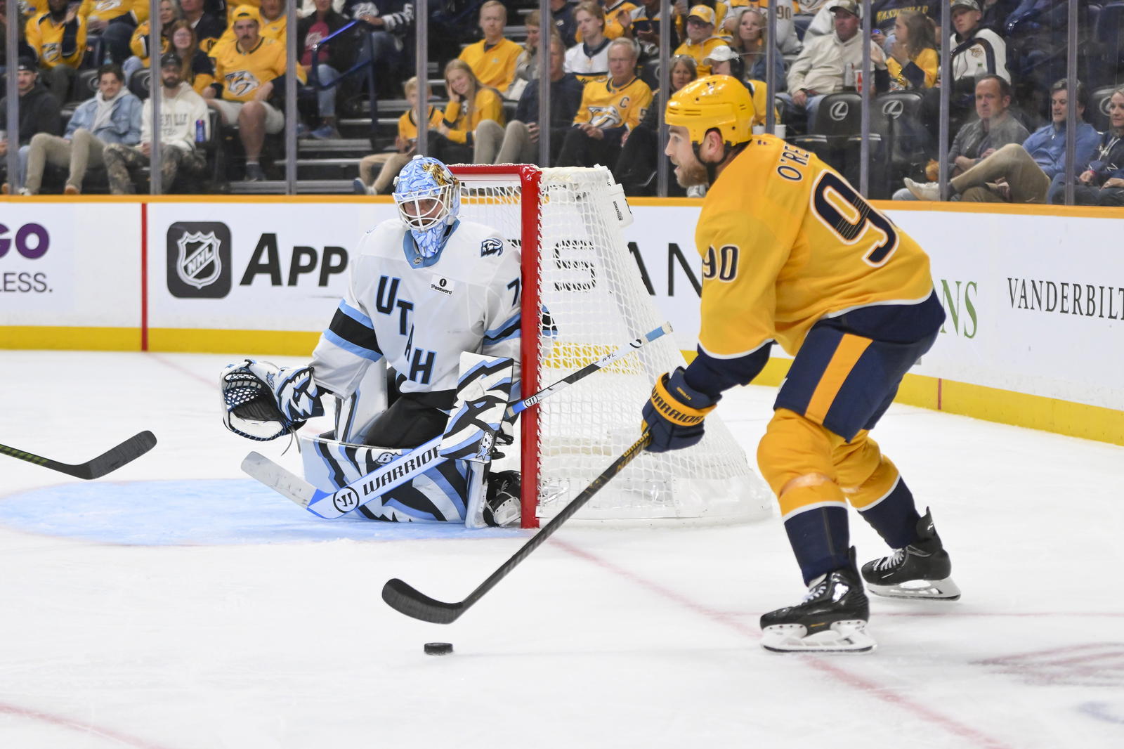 Oct 11, 2025; Nashville, Tennessee, USA; Nashville Predators center Ryan O'Reilly (90) checks put the ice against the Utah Mammoth during the third period at Bridgestone Arena. Steve Roberts-Imagn Images