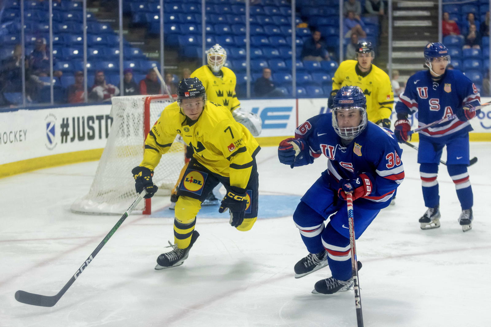 Aug 2, 2024; Plymouth, MI, USA; USA’s goaltender LJ Mooney (36) skates after a loose puck next to Sweden's defenseman Albert Wikman (7) during the third period of the 2024 World Junior Summer Showcase at USA Hockey Arena. Mandatory Credit: David Reginek-Imagn Images