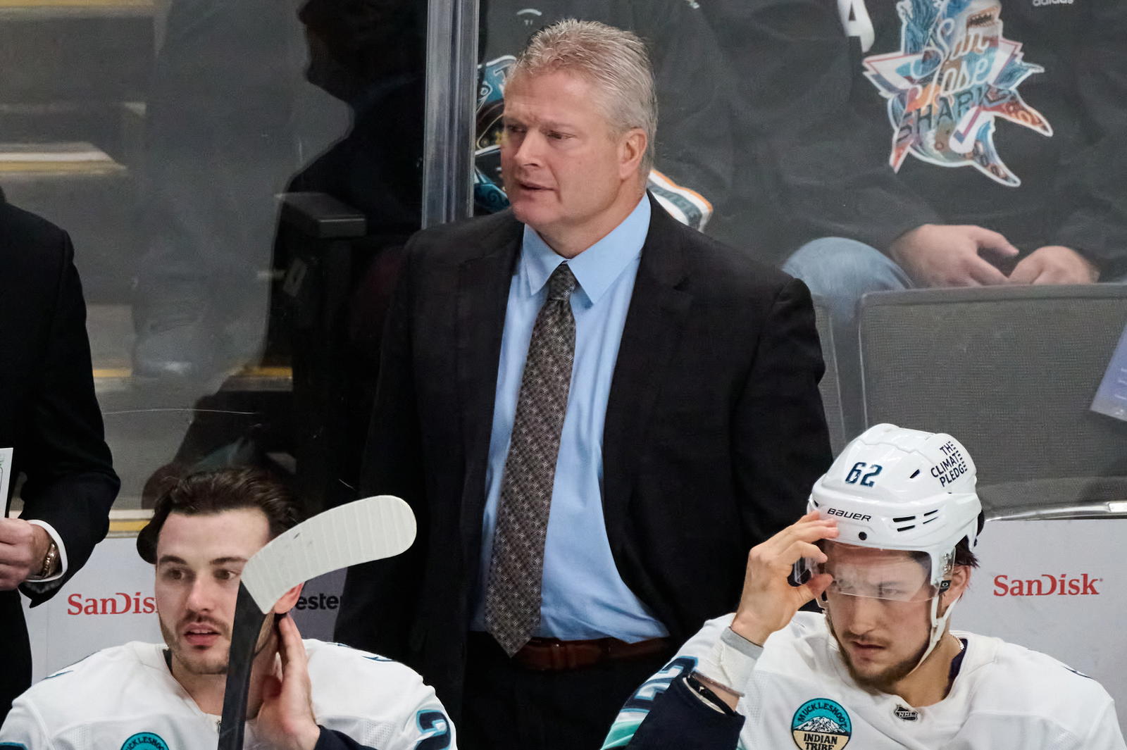 Seattle Kraken assistant coach Bob Woods watches the play from the bench against the San Jose Sharks with defenseman Joshua Mahura (28) and defenseman Brandon Montour (62) during the third period at SAP Center at San Jose. Mandatory Credit: Robert Edwards-Imagn Images