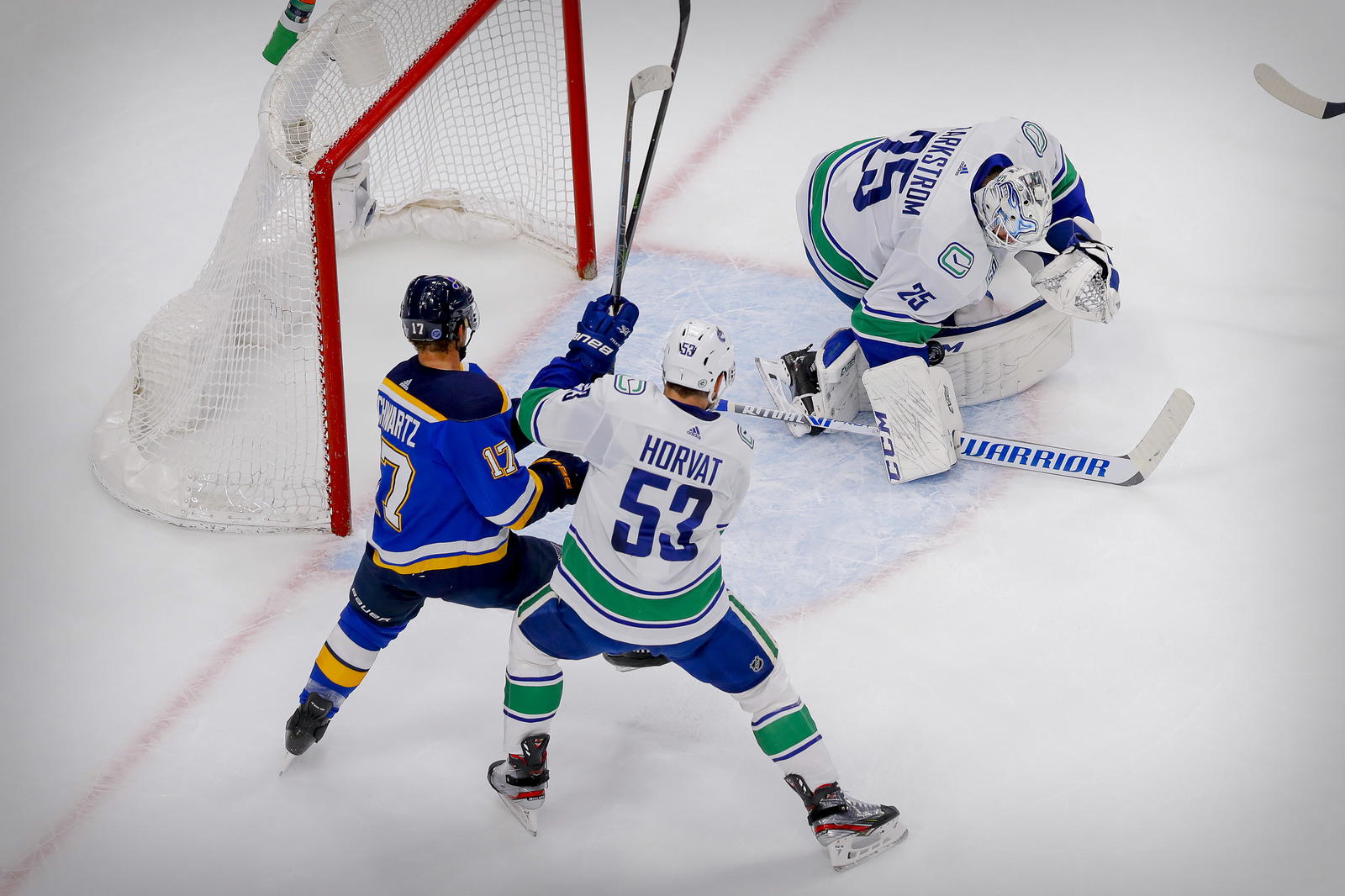 Aug 19, 2020; Edmonton, Alberta, CAN; Vancouver Canucks goaltender Jacob Markstrom (25) and center Bo Horvat (53) defend against St. Louis Blues left wing Jaden Schwartz (17) during the first period in game five of the first round of the 2020 Stanley Cup Playoffs at Rogers Place. Mandatory Credit: Perry Nelson-Imagn Images