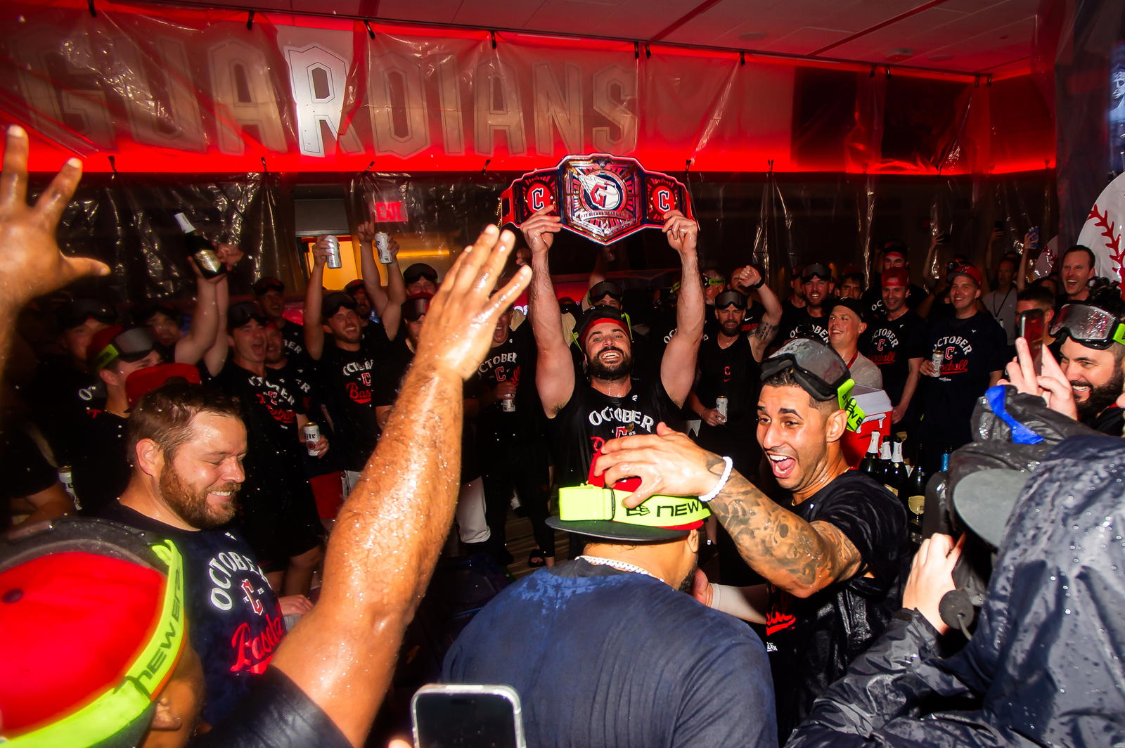 Sep 27, 2025; Cleveland, Ohio, USA; Cleveland Guardians catcher Austin Hedges, with belt, and shortstop Brayan Rocchio, right, along with the team and staff celebrate after the Guardians beat the Texas Rangers and clinched a playoff berth at Progressive Field. Mandatory Credit: Ken Blaze-Imagn Images