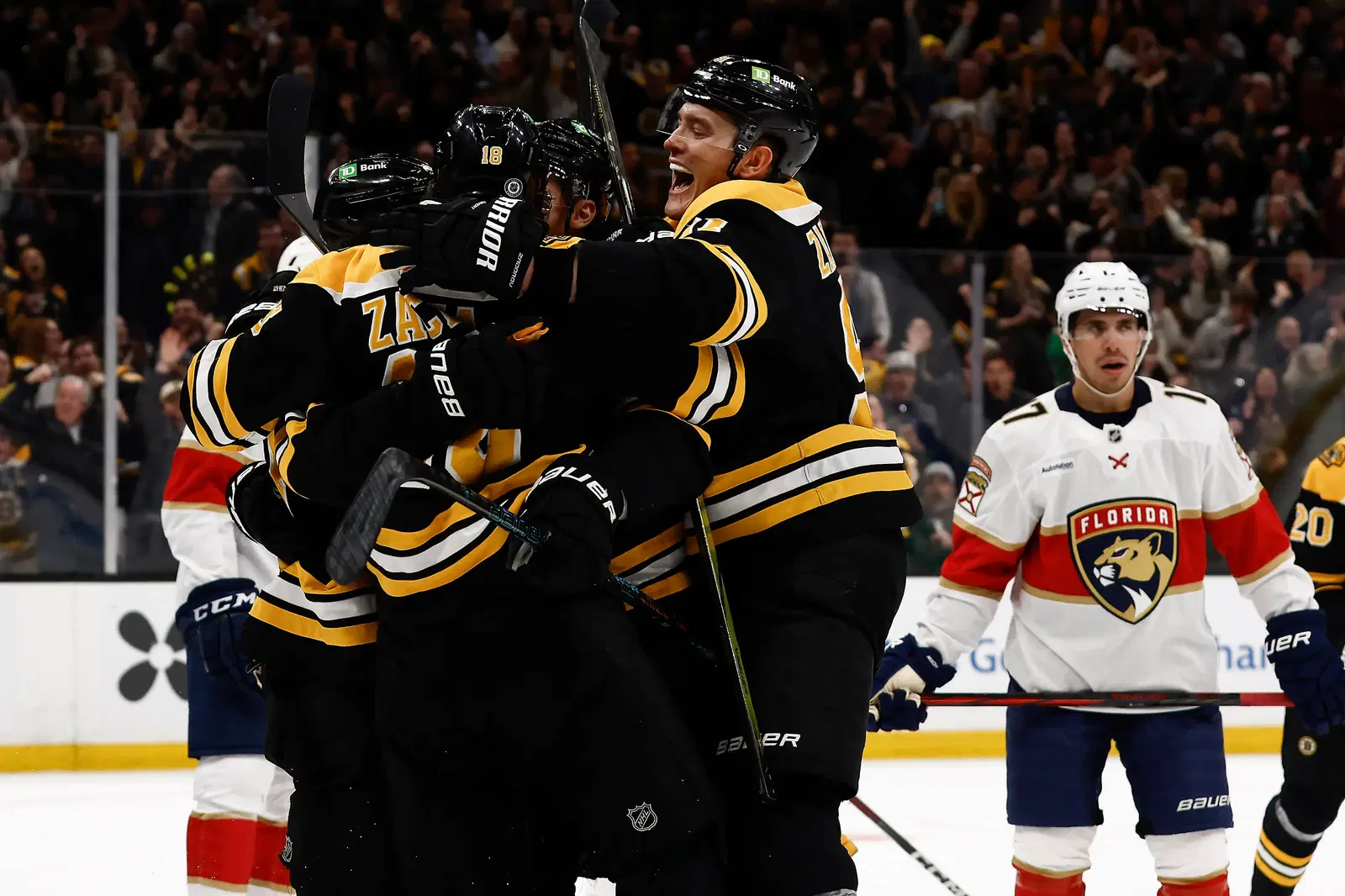 Mar 11, 2025; Boston, Massachusetts, USA; Boston Bruins defenseman Nikita Zadorov (91) joins the celebration after center Pavel Zacha (18) scored the go ahead goal as Florida Panthers center Evan Rodrigues (17) looks away during the third period at TD Garden. (Winslow Townson-Imagn Images)