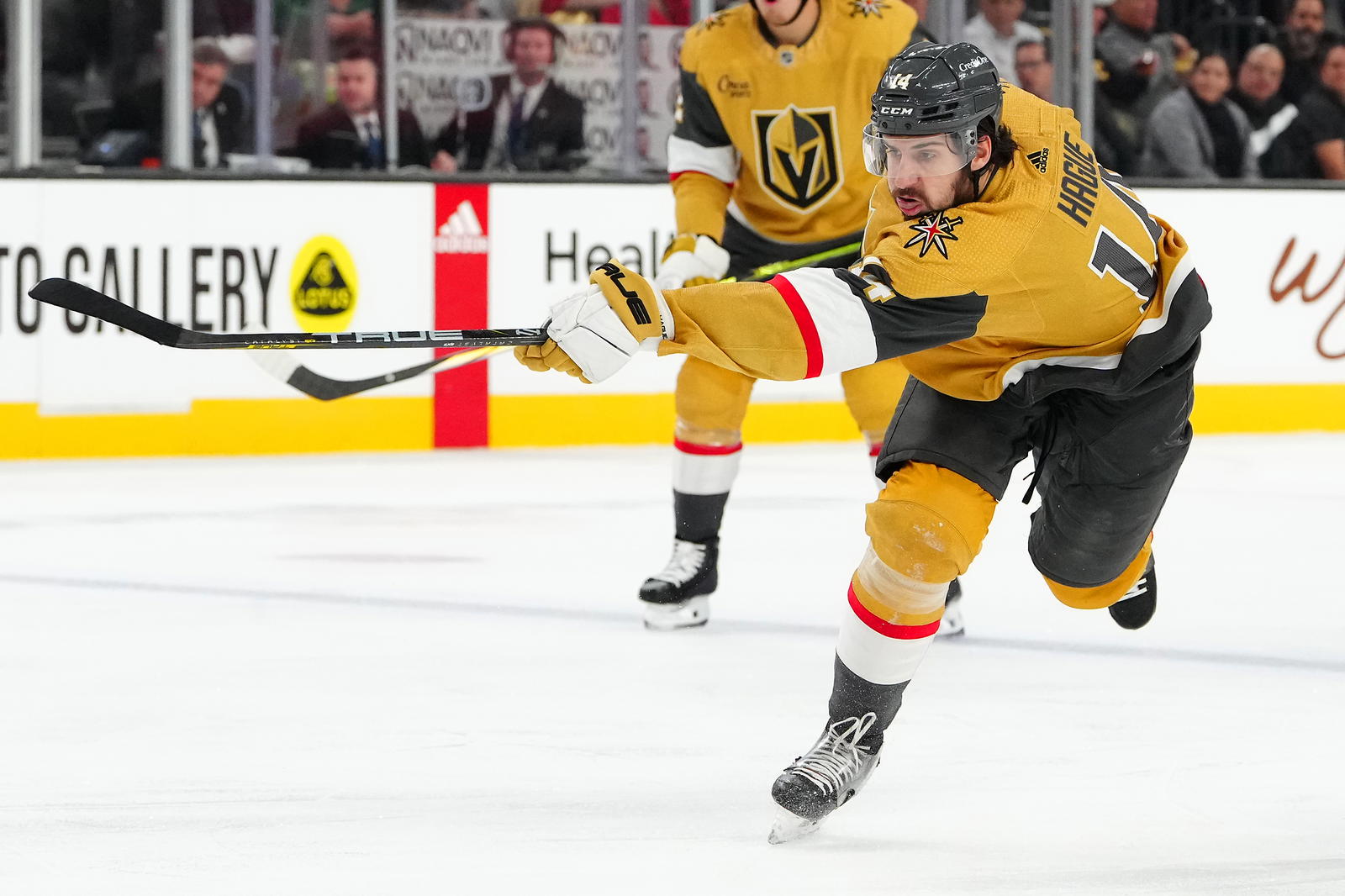 Dec 4, 2023; Las Vegas, Nevada, USA; Vegas Golden Knights defenseman Nicolas Hague (14) shoots against the St. Louis Blues during the second period at T-Mobile Arena. Mandatory Credit: Stephen R. Sylvanie-Imagn Images