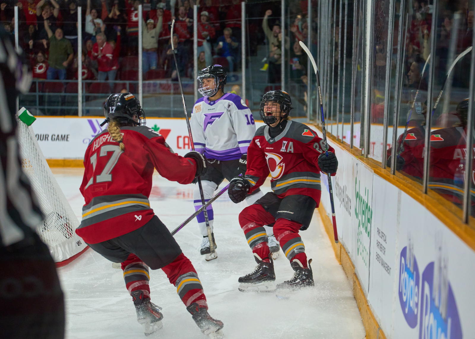 Emily Clark (26) celebrates her overtime winning goal as linemate Gabbie Hughes prepares to leap toward her to start the post game celebrations -&nbsp;Photo @ Ellen Bond