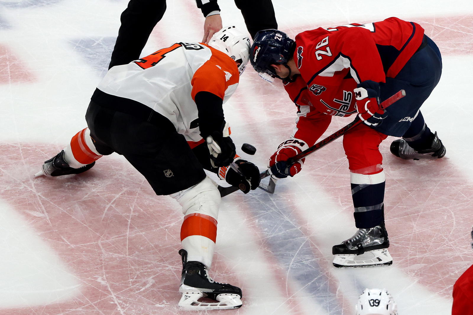 Mar 20, 2025; Washington, District of Columbia, USA; Philadelphia Flyers center Sean Couturier (14) and Washington Capitals center Nic Dowd (26) face off during the third period at Capital One Arena. Mandatory Credit: Daniel Kucin Jr.-Imagn Images