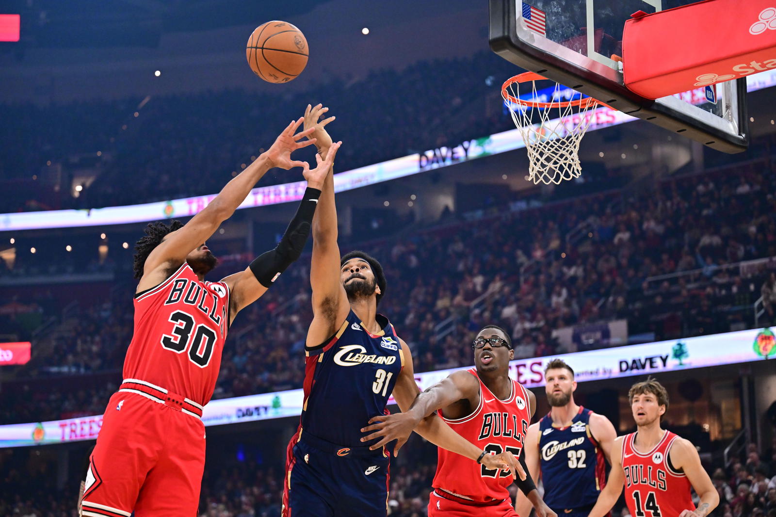 Nov 8, 2025; Cleveland, Ohio, USA; Chicago Bulls guard Tre Jones (30) andCleveland Cavaliers center Jarrett Allen (31) go for a rebound during the first half at Rocket Arena. Mandatory Credit: Ken Blaze-Imagn Images