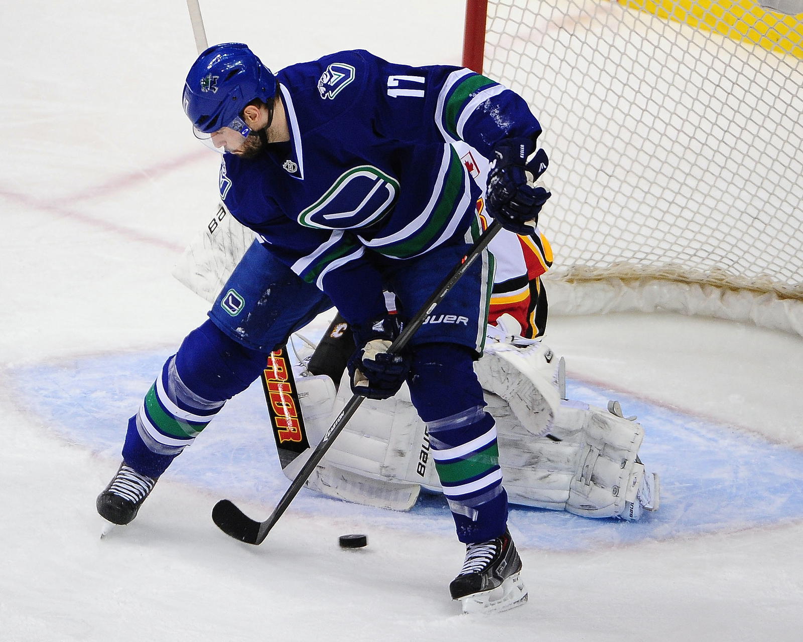Apr 13, 2014; Vancouver, British Columbia, CAN; Vancouver Canucks forward Ryan Kesler (17) moves the puck in front of Calgary Flames goaltender Karri Ramo (31) during the second period at Rogers Arena. Mandatory Credit: Anne-Marie Sorvin-Imagn Images