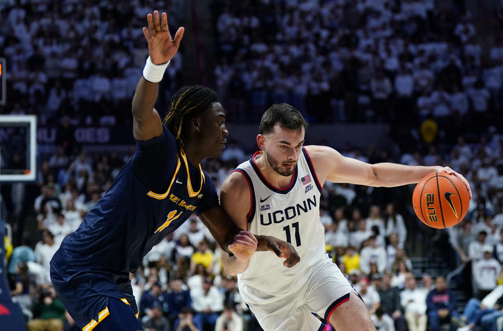 UConn forward Alex Karaban (11) drives the ball against New Haven guard/forward Teshaun Steele (14) in the second half at Harry A. Gampel Pavilion in Storrs, Conn., on Nov. 3. Credit: David Butler II-Imagn Images