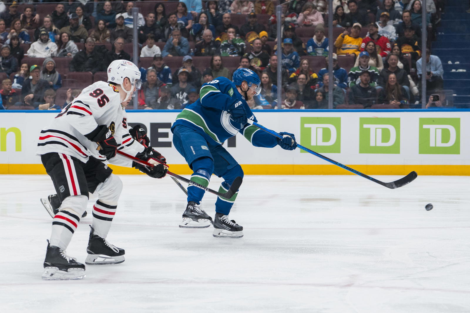 Mar 15, 2025; Vancouver, British Columbia, CAN; Chicago Blackhawks forward Ilya Mikheyev (95) watches as Vancouver Canucks forward Elias Pettersson (40) scores on this shot in the third period at Rogers Arena. Mandatory Credit: Bob Frid-Imagn Images