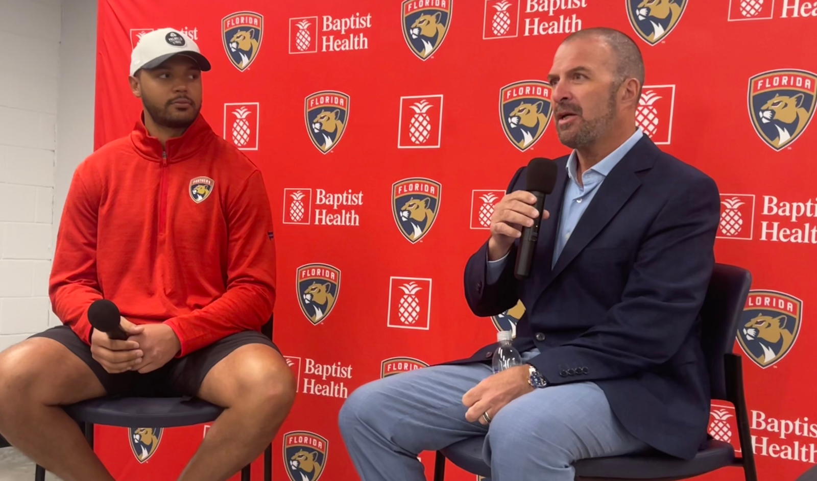 Florida Panthers GM Bill Zito (right) speaks to the media during Seth Jones' (left) introductory press conference at the Baptist Health IcePlex in Fort Lauderdale on March 3, 2025. (David Dwork)