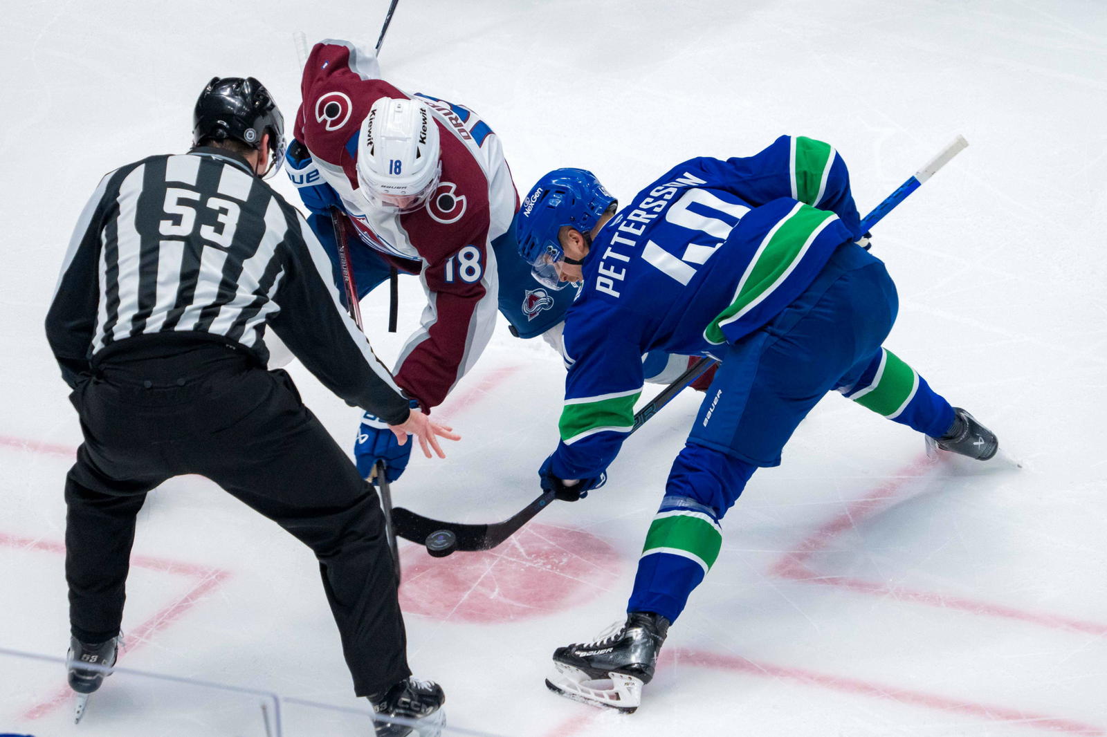 Feb 4, 2025; Vancouver, British Columbia, CAN; Vancouver Canucks forward Elias Pettersson (40) wins a faceoff draw against Colorado Avalanche forward Jack Drury (18) in the first period at Rogers Arena. Mandatory Credit: Bob Frid-Imagn Images