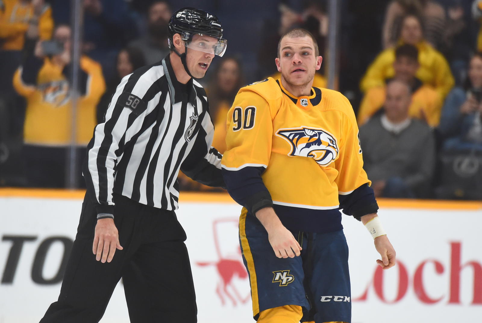 Nov 30, 2021; Nashville, Tennessee, USA; Nashville Predators defenseman Mark Borowiecki (90) is escorted to the penalty box by linesman Ryan Gibbons (58) after a roughing penalty during the third period at Bridgestone Arena. Mandatory Credit: Christopher Hanewinckel-Imagn Images