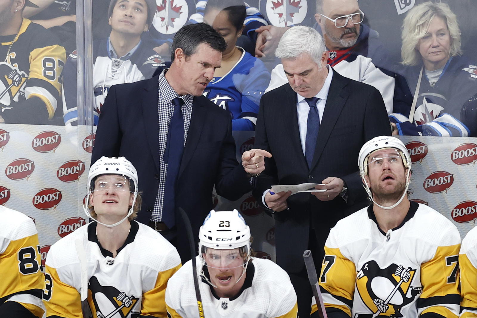 Nov 19, 2022; Winnipeg, Manitoba, CAN; Pittsburgh Penguins head coach Mike Sullivan and assistant coach Mike Vellucci discuss a play during a break action against the Winnipeg Jets in the third period at Canada Life Centre. Mandatory Credit: James Carey Lauder-Imagn Images