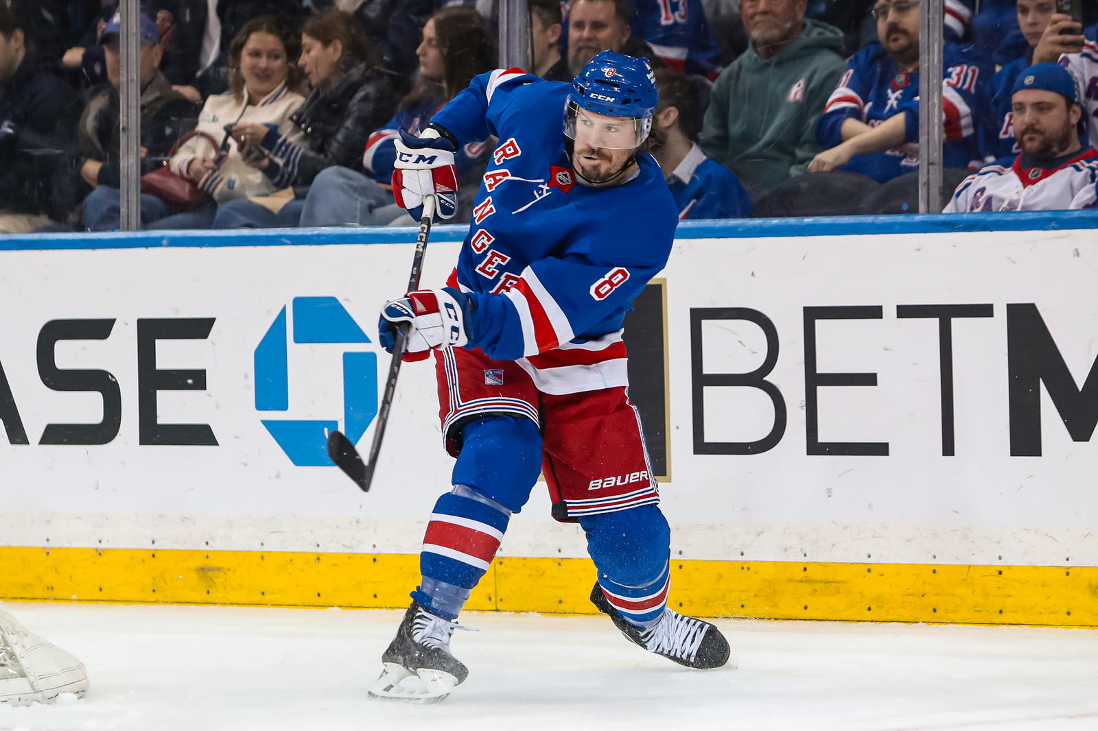 Mar 22, 2025; New York, New York, USA; New York Rangers center J.T. Miller (8) clears the puck against the Vancouver Canucks during the second period at Madison Square Garden. Mandatory Credit: Danny Wild-Imagn Images