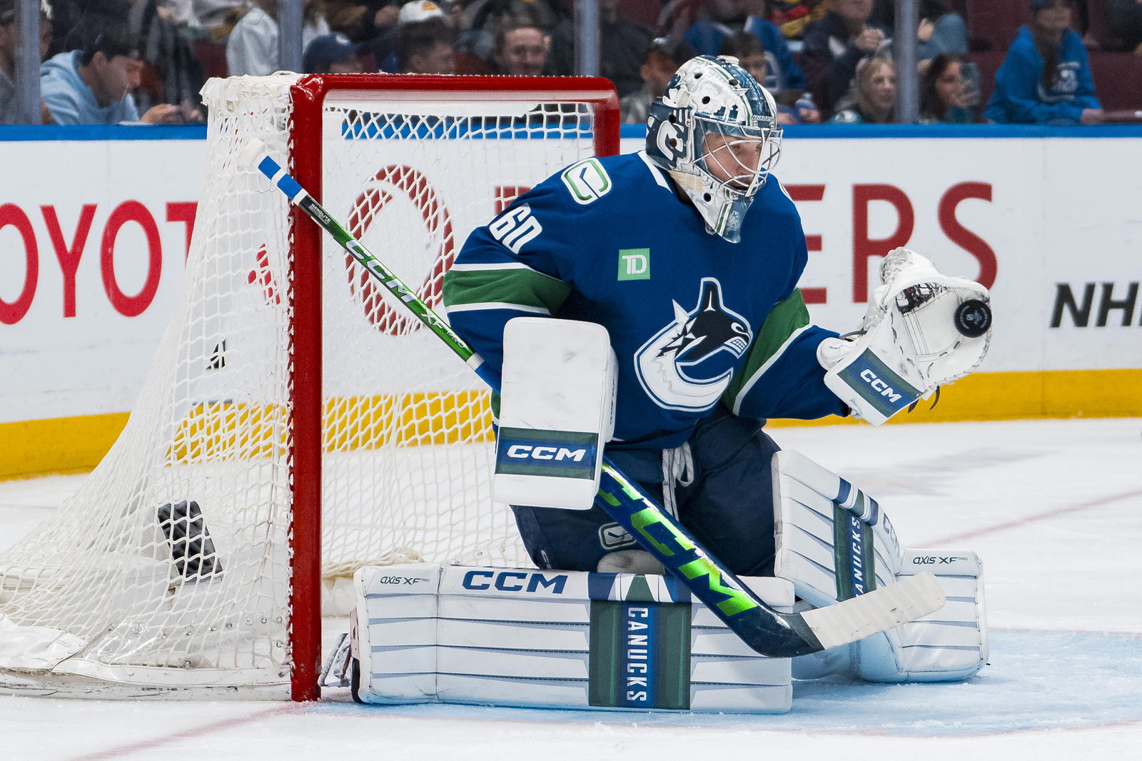 Apr 14, 2025; Vancouver, British Columbia, CAN; Vancouver Canucks goalie Nikita Tolopilo (60) makes a save against the San Jose Sharks in the third period at Rogers Arena. Mandatory Credit: Bob Frid-Imagn Images
