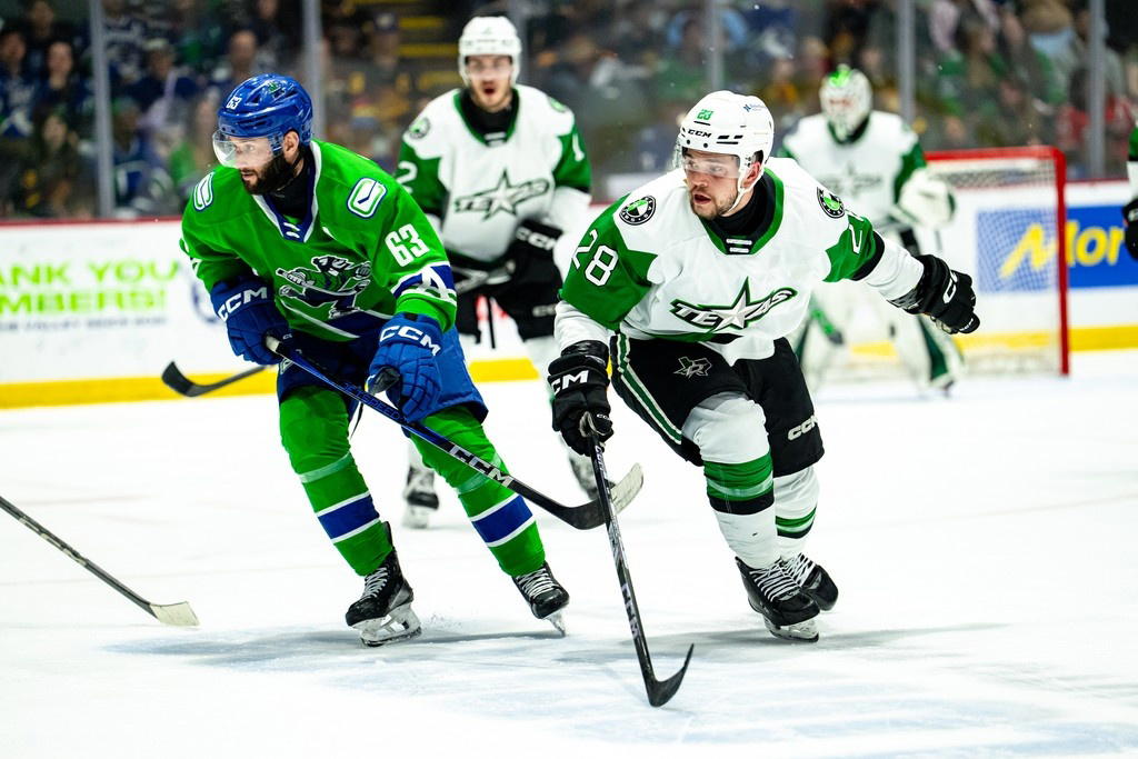 Abbotsford Canucks forward Max Sasson (63) and Texas Stars forward Matěj Blümel skate up the ice. (Photo Credit: @TheAHL/X) 