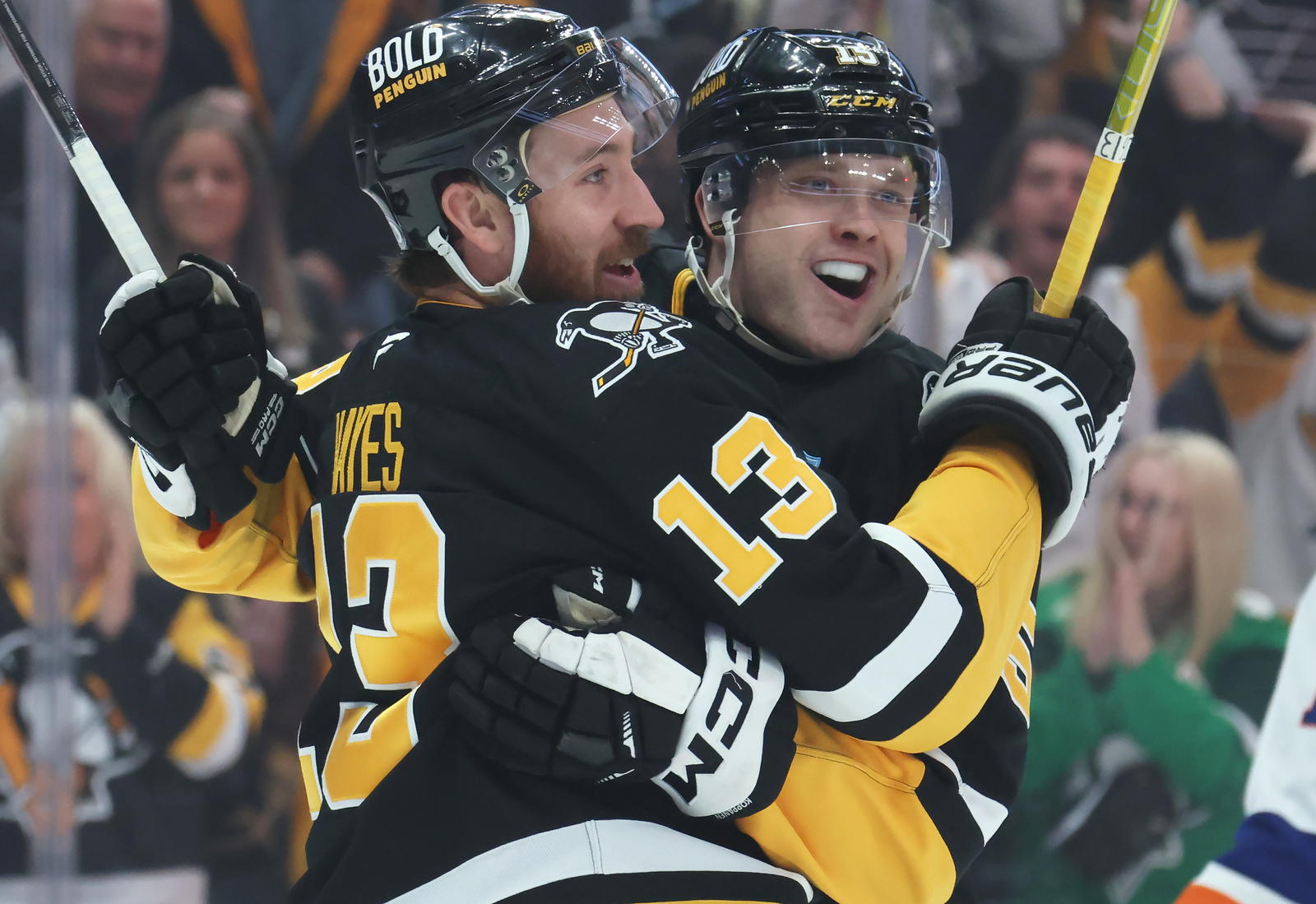Mar 18, 2025; Pittsburgh, Pennsylvania, USA; Pittsburgh Penguins right wing Kevin Hayes (13) and left wing Joona Koppanen (right) celebrate the first NHL career goal by Koppanen against the New York Islanders during the first period at PPG Paints Arena. Mandatory Credit: Charles LeClaire-Imagn Images