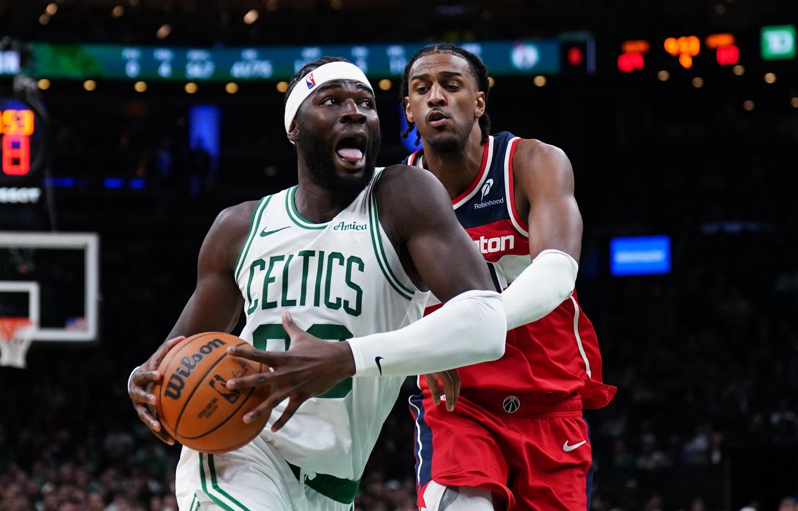 Nov 5, 2025; Boston, Massachusetts, USA; Boston Celtics center Neemias Queta (88) drives the ball against Washington Wizards center Alex Sarr (20) in the second half at TD Garden. (David Butler II/Imagn Images)