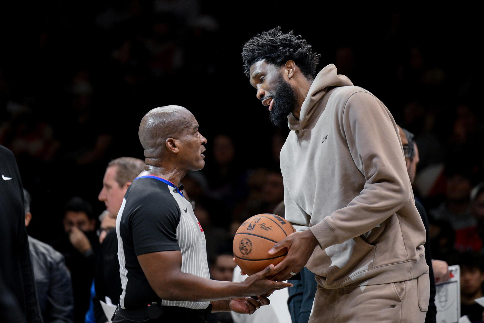 Nov 2, 2025; Brooklyn, New York, USA; Philadelphia 76ers center Joel Embiid (21) chats with referee Derrick Collins (11) during the second half at Barclays Center. (John Jones/Imagn Images)