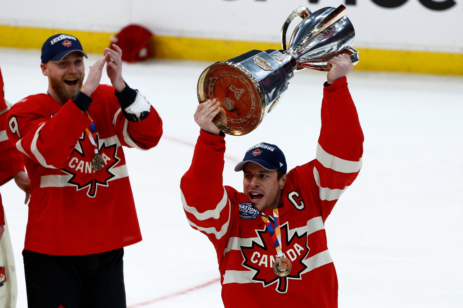 Feb 20, 2025; Boston, MA, USA; Team Canada forward Sidney Crosby (87) lifts the 4 Nations Face-Off trophy after winning against Team USA in overtime during the 4 Nations Face-Off ice hockey championship game at TD Garden. (Brian Fluharty-Imagn Images)