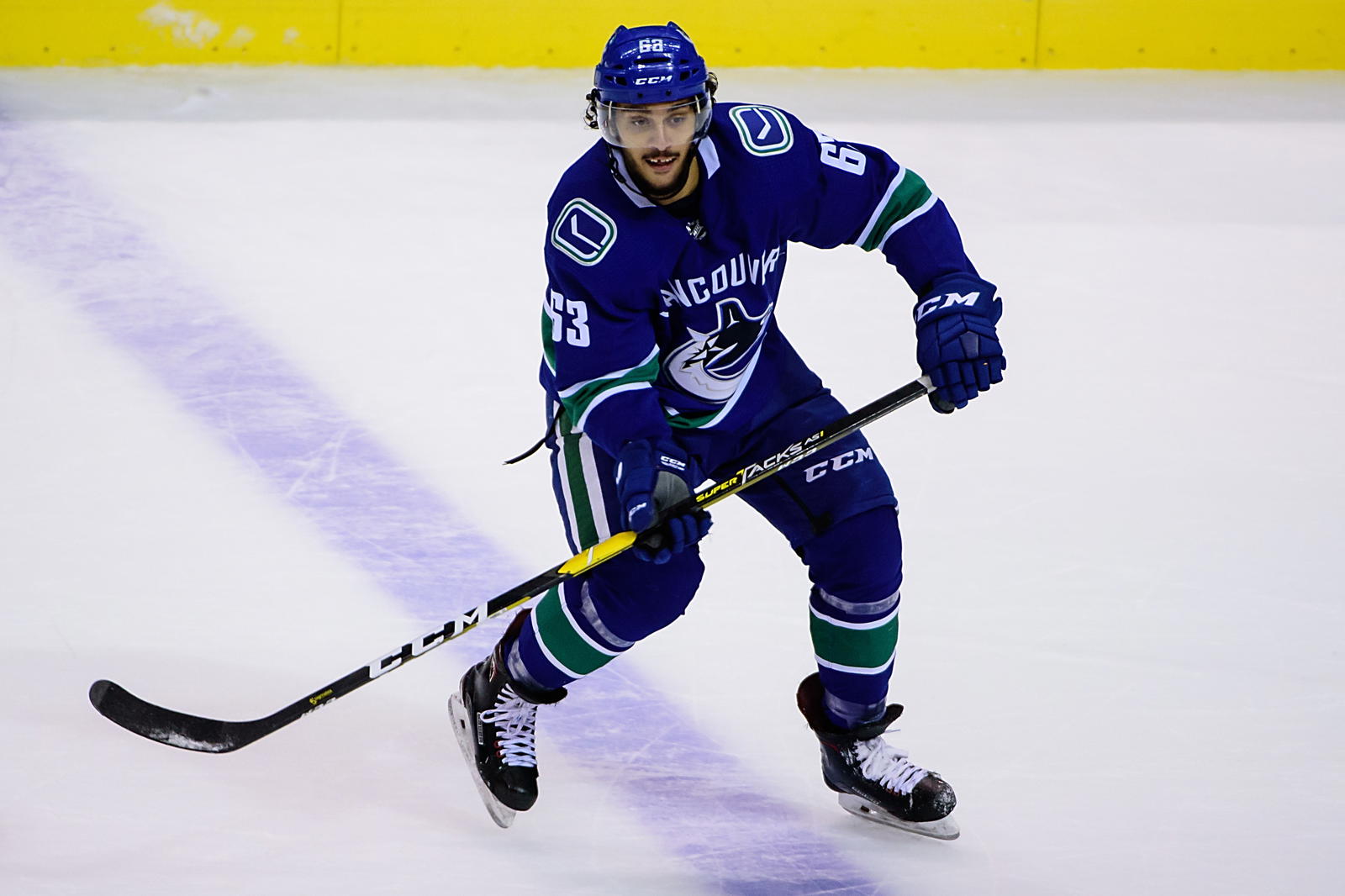 Sep 19, 2018; Vancouver, British Columbia, CAN; Vancouver Canucks defenseman Jalen Chatfield (63) skates with the puck during the third period at Rogers Arena. (Anne-Marie Sorvin-Imagn Images)