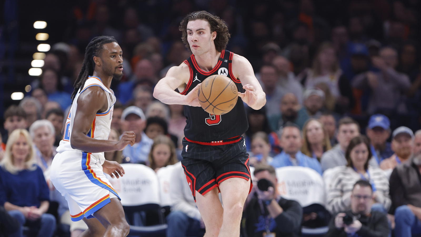 Mar 31, 2025; Oklahoma City, Oklahoma, USA; Chicago Bulls guard Josh Giddey (3) passes around Oklahoma City Thunder guard Cason Wallace (22) during the second quarter at Paycom Center. Mandatory Credit: Alonzo Adams-Imagn Images