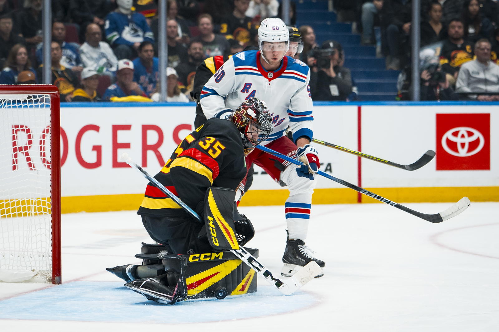 Oct 28, 2025; Vancouver, British Columbia, CAN; New York Rangers forward Will Cuylle (50) watches as Vancouver Canucks goalie Thatcher Demko (35) makes a save in the third period at Rogers Arena. Mandatory Credit: Bob Frid-Imagn Images