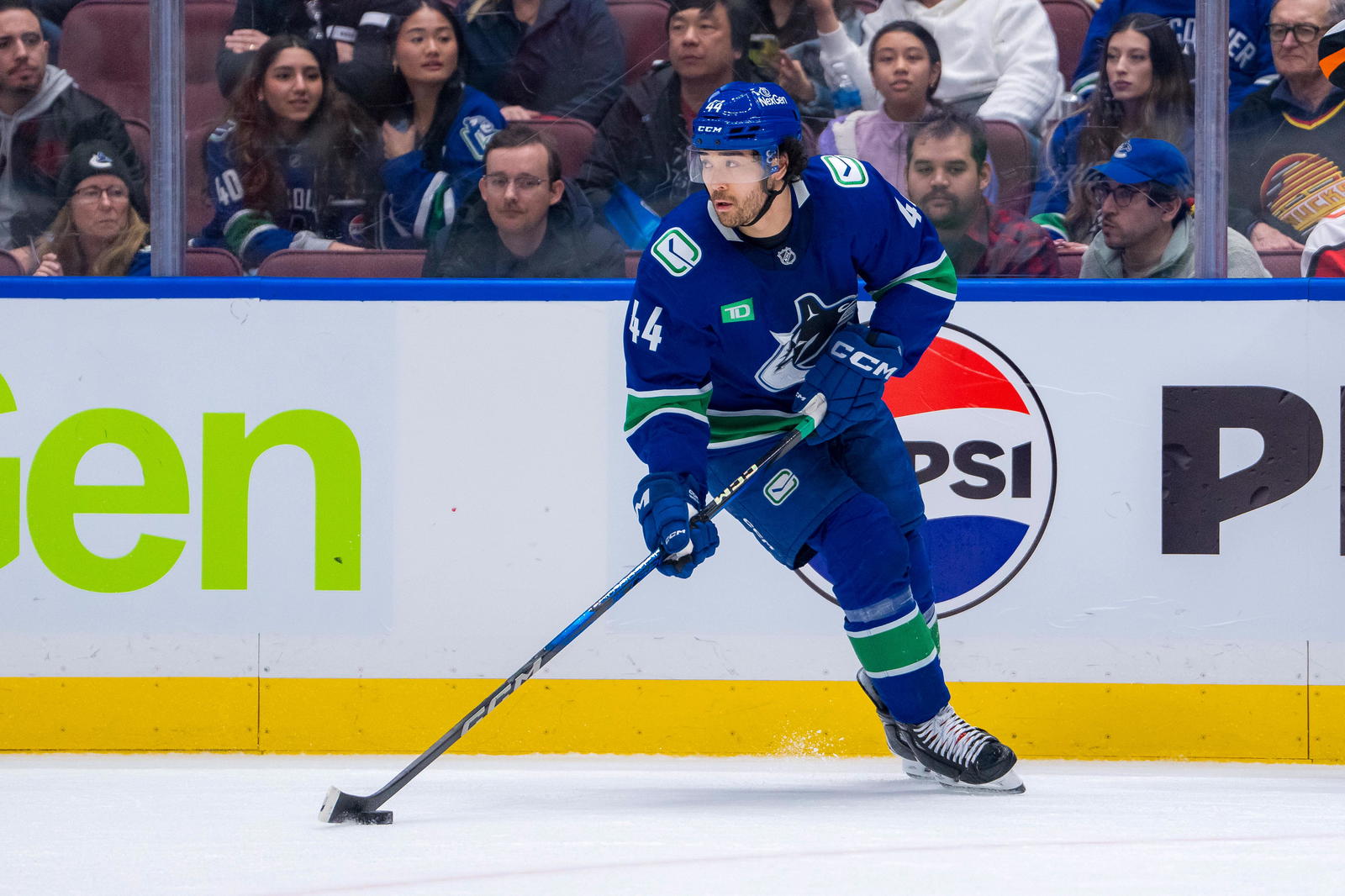 Feb 2, 2025; Vancouver, British Columbia, CAN; Vancouver Canucks forward Kiefer Sherwood (44) handles the puck against the Detroit Red Wings in overtime at Rogers Arena. Mandatory Credit: Bob Frid-Imagn Images