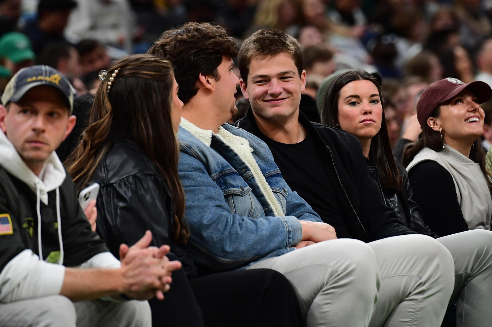 Nov 3, 2025; Boston, Massachusetts, USA; New England Patriots quarterback Drake Maye sits with teammate Will Campbell during the second half in a game between the Boston Celtics and Utah Jazz at TD Garden. (Bob DeChiara/Imagn Images)