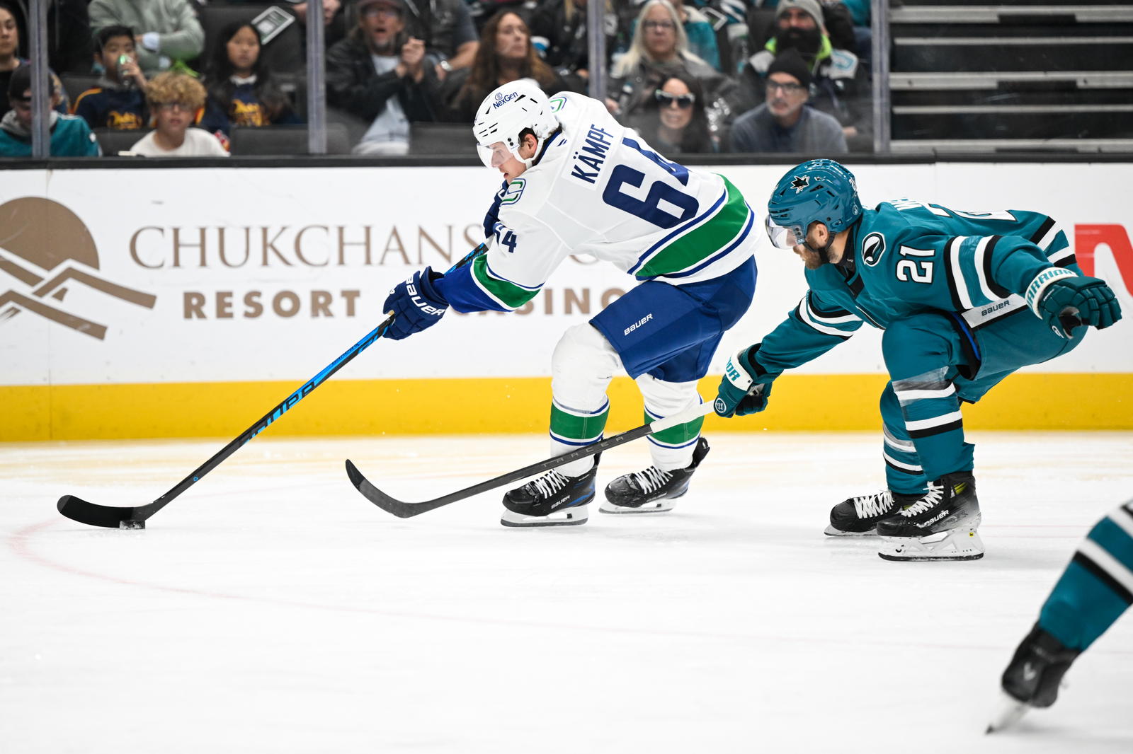 Nov 28, 2025; San Jose, California, USA; Vancouver Canucks center David Kampf (64) controls the puck against San Jose Sharks center Alexander Wennberg (21) in the first period at SAP Center at San Jose. Mandatory Credit: Eakin Howard-Imagn Images