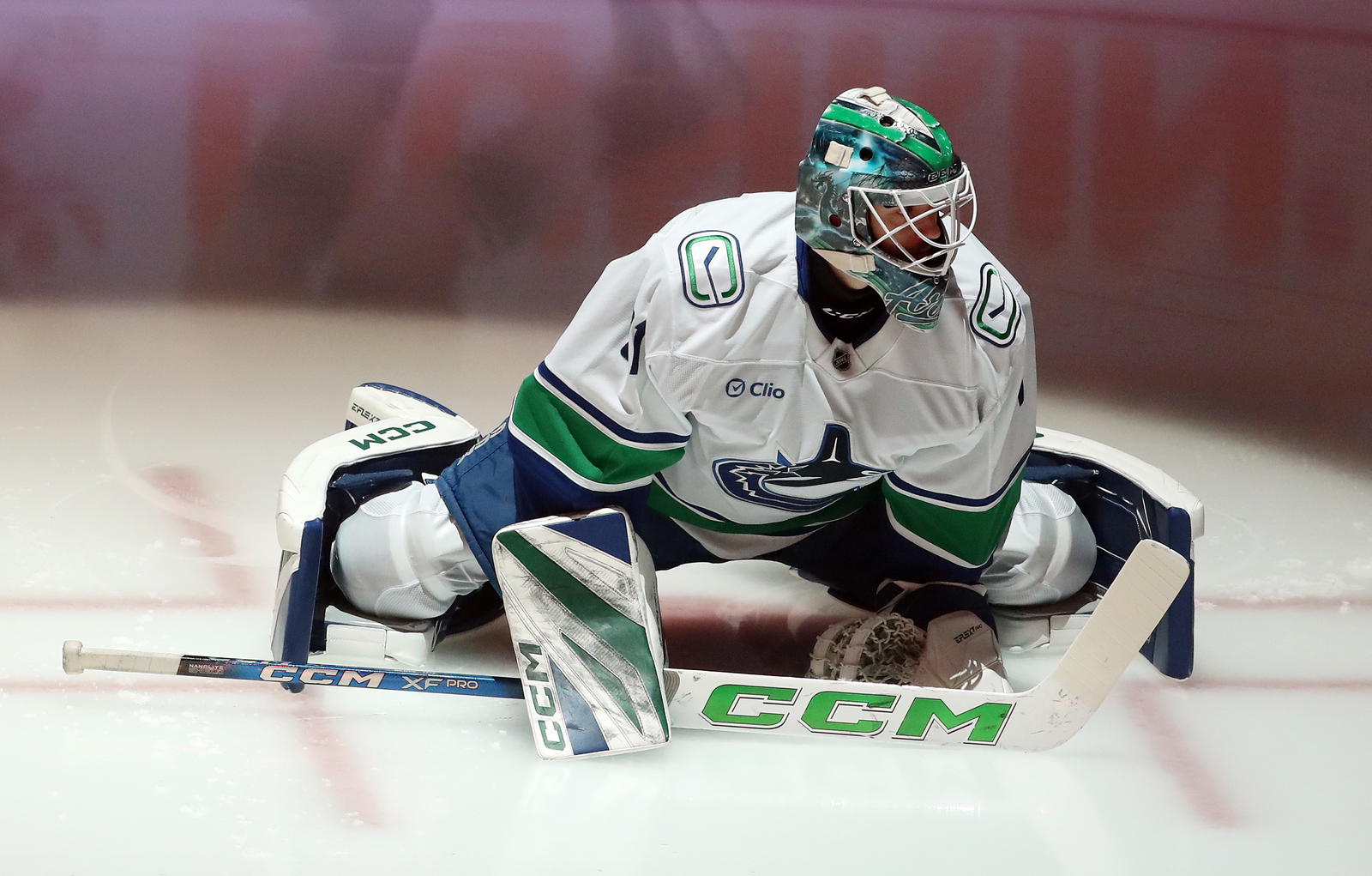 Nov 27, 2024; Pittsburgh, Pennsylvania, USA; Vancouver Canucks goaltender Arturs Silovs (31) stretches on the ice to warm up against the Pittsburgh Penguins at PPG Paints Arena. Mandatory Credit: Charles LeClaire-Imagn Images