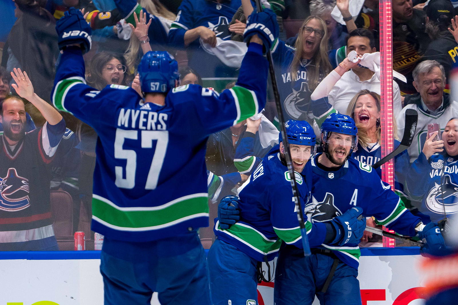 May 16, 2024; Vancouver, British Columbia, CAN; Vancouver Canucks defenseman Tyler Myers (57) and defenseman Carson Soucy (7) and forward J.T. Miller (9) celebrate Miller’s game winning goal against the Edmonton Oilers during the third period in game five of the second round of the 2024 Stanley Cup Playoffs at Rogers Arena. Mandatory Credit: Bob Frid-Imagn Images