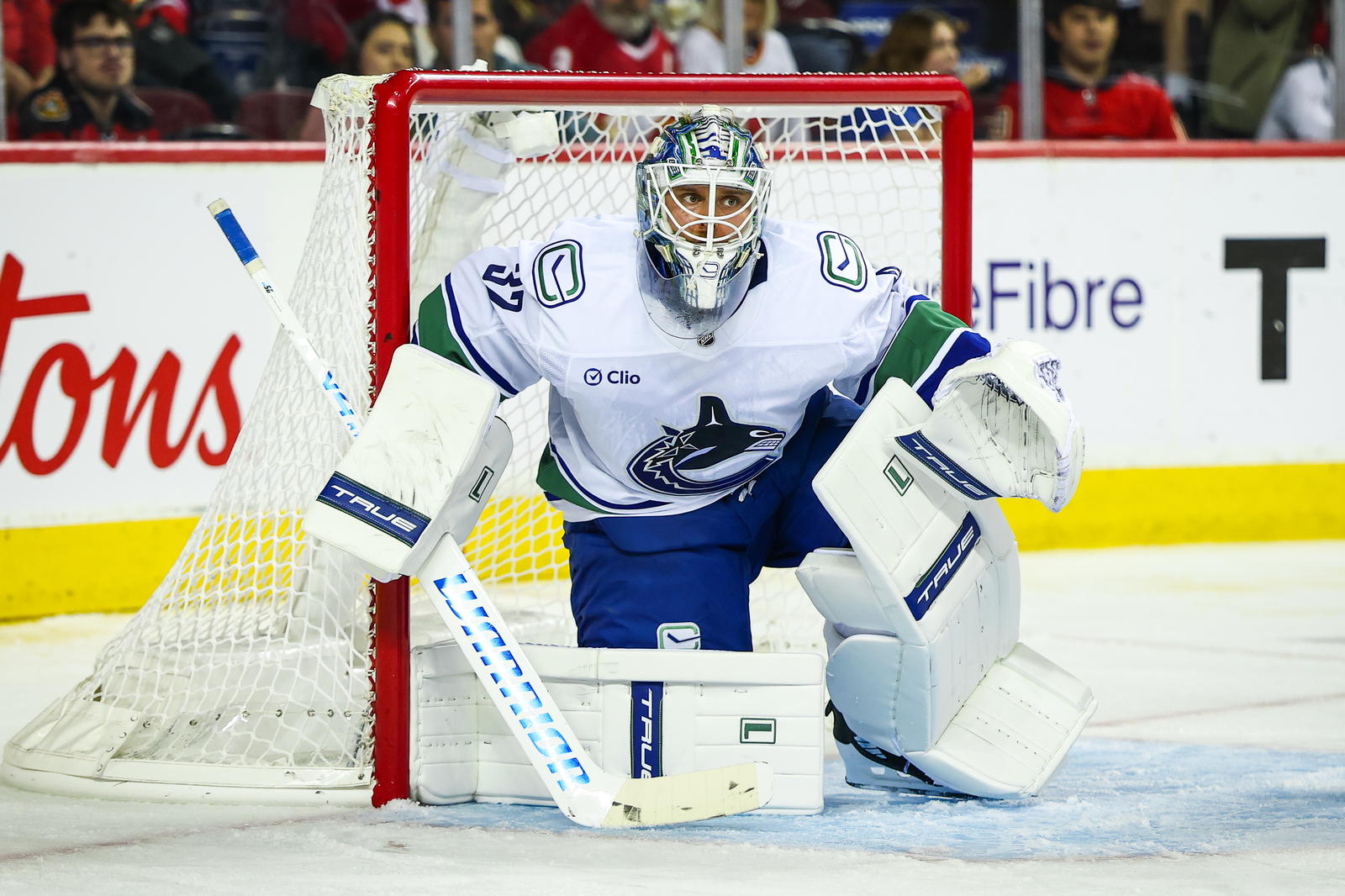 Oct 1, 2025; Calgary, Alberta, CAN; Vancouver Canucks goaltender Kevin Lankinen (32) guards his net against the Calgary Flames during the second period at Scotiabank Saddledome. Mandatory Credit: Sergei Belski-Imagn Images