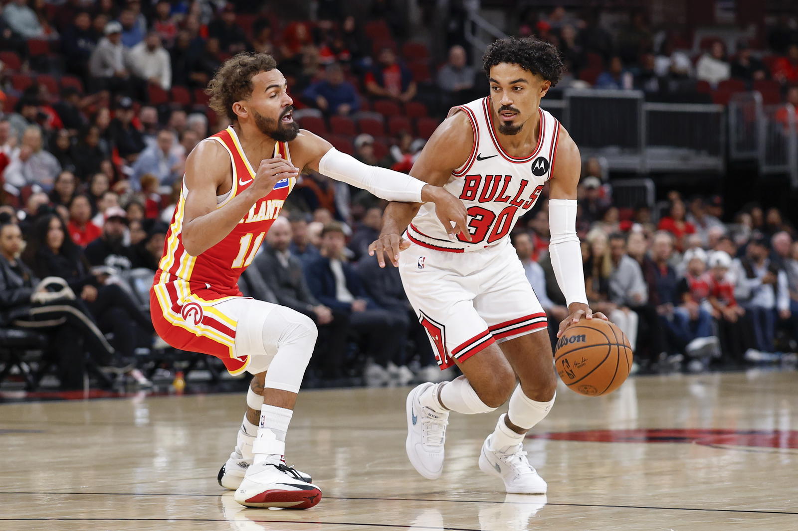 Oct 27, 2025; Chicago, Illinois, USA; Chicago Bulls guard Tre Jones (30) drives to the basket against Atlanta Hawks guard Trae Young (11) during the first half at United Center. Mandatory Credit: Kamil Krzaczynski-Imagn Images