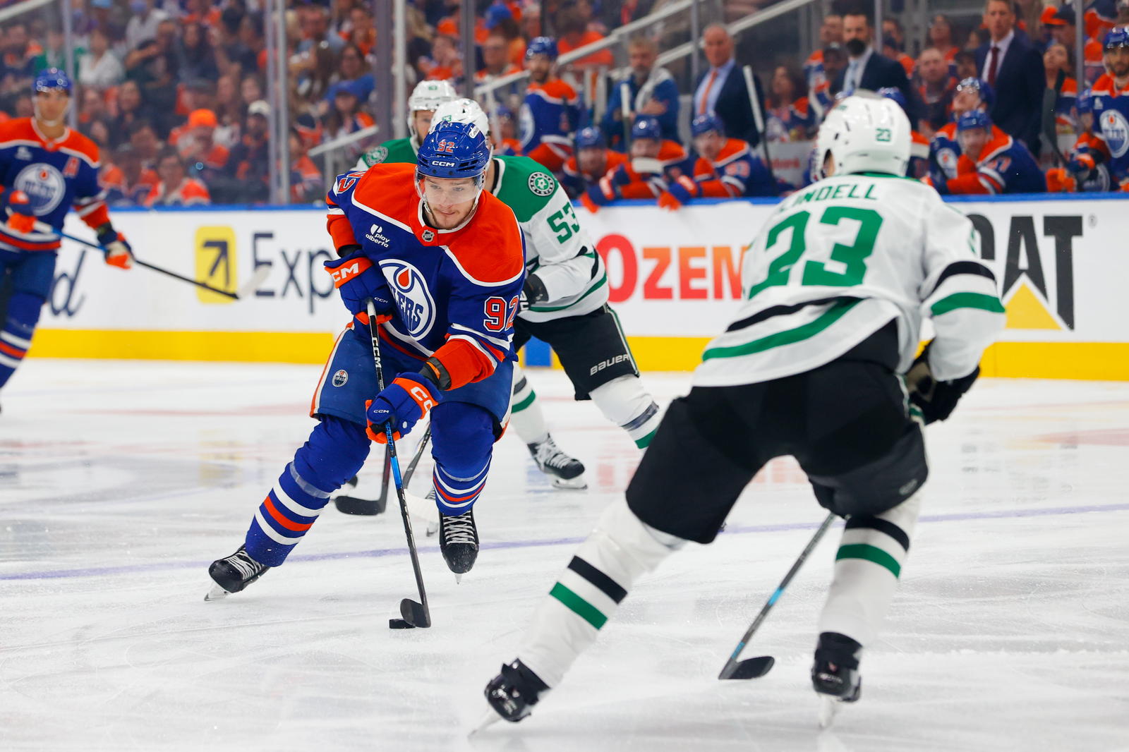 May 25, 2025; Edmonton, Alberta, CAN; Edmonton Oilers right wing Vasily Podkolzin (92) skates with the puck against Dallas Stars defenseman Esa Lindell (23) during the first period in game three of the Western Conference Final of the 2025 Stanley Cup Playoffs at Rogers Place. Mandatory Credit: Perry Nelson-Imagn Images