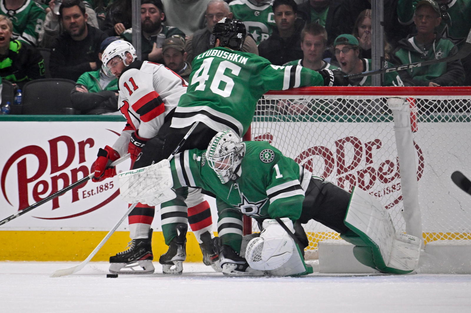 Mar 4, 2025; Dallas, Texas, USA; Dallas Stars goaltender Casey DeSmith (1) and defenseman Ilya Lyubushkin (46) and New Jersey Devils right wing Stefan Noesen (11) battle for control of the puck during the second period at the American Airlines Center.