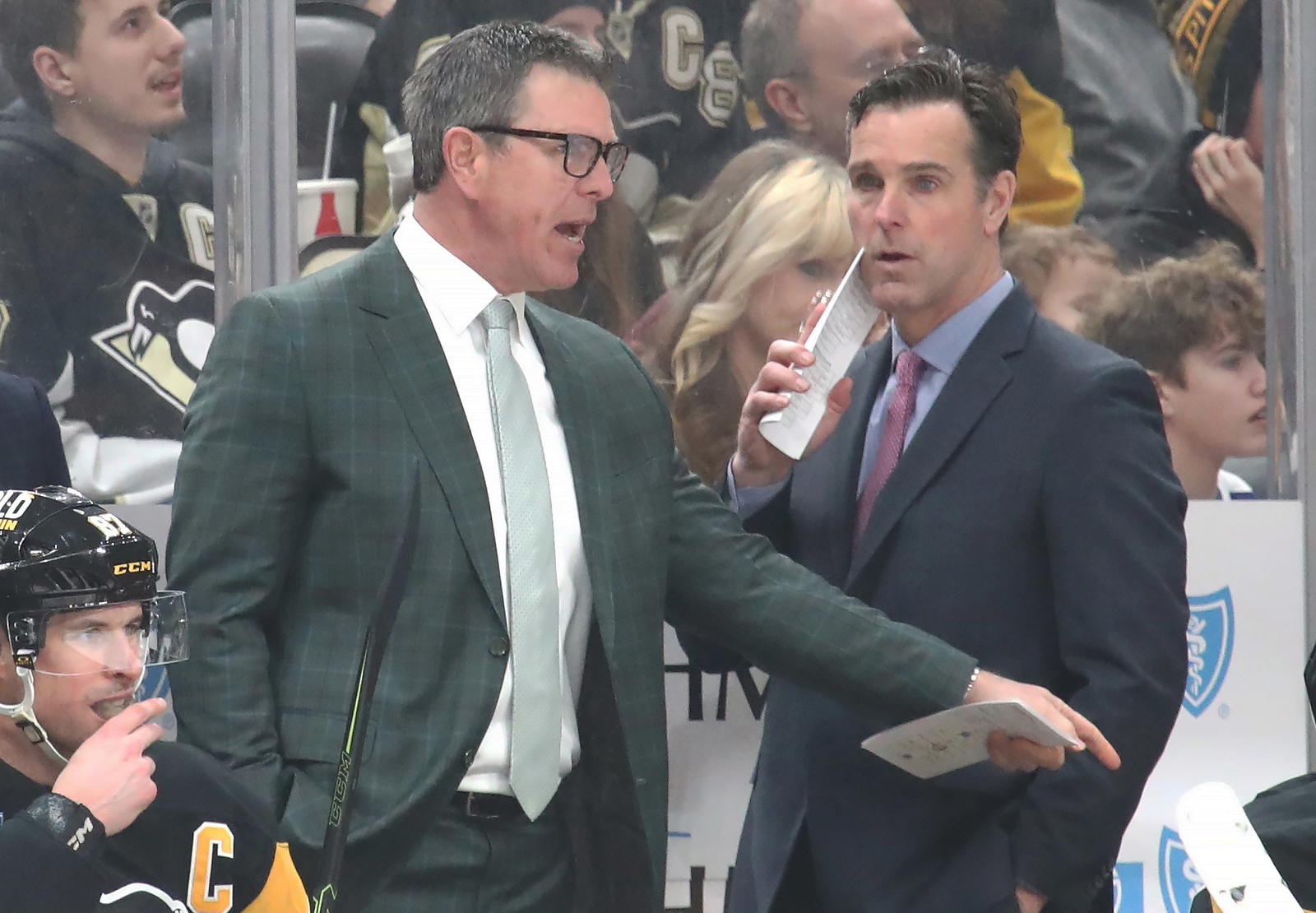 Mar 2, 2025; Pittsburgh, Pennsylvania, USA; Pittsburgh Penguins head coach Mike Sullivan (left) gestures on the bench as assistant coach David Quinn (right) looks on against the Toronto Maple Leafs in overtime at PPG Paints Arena. Mandatory Credit: Charles LeClaire-Imagn Images