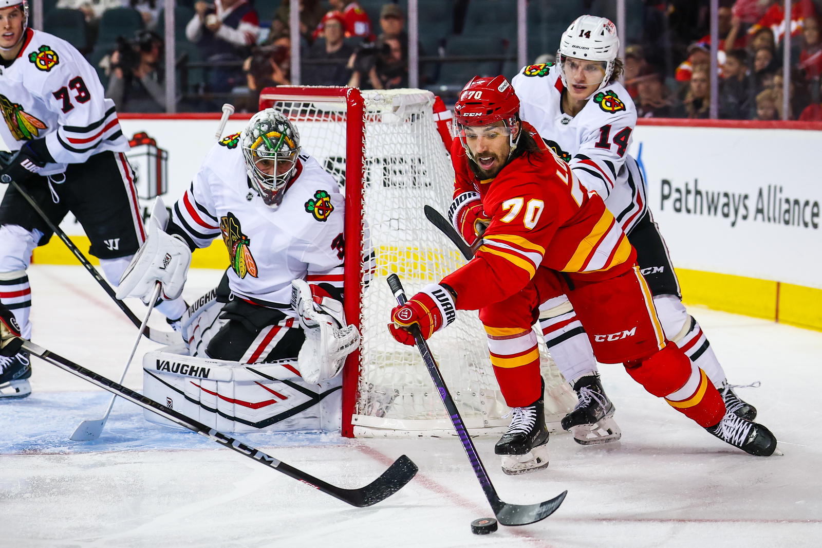 Calgary Flames left wing Ryan Lomberg (70) passes the puck against the Chicago Blackhawks during their game at the Scotiabank Saddledome in Calgary (Source: Sergei Belski-Imagn Images)