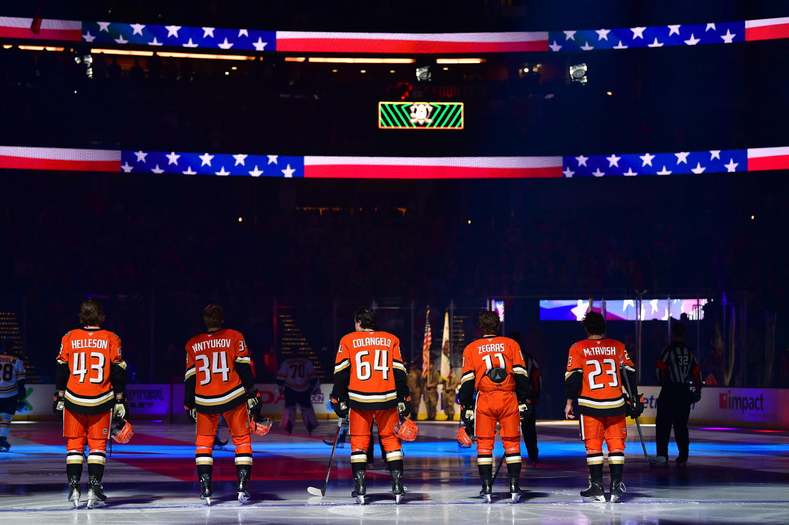 Mar 26, 2025; Anaheim, California, USA; Anaheim Ducks defenseman Drew Helleson (43) defenseman Pavel Mintyukov (34) right wing Sam Colangelo (64) center Trevor Zegras (11) and center Mason McTavish (23) during the national anthem before playing against the Boston Bruins at Honda Center. Photo Credit: Gary A. Vasquez-Imagn Images