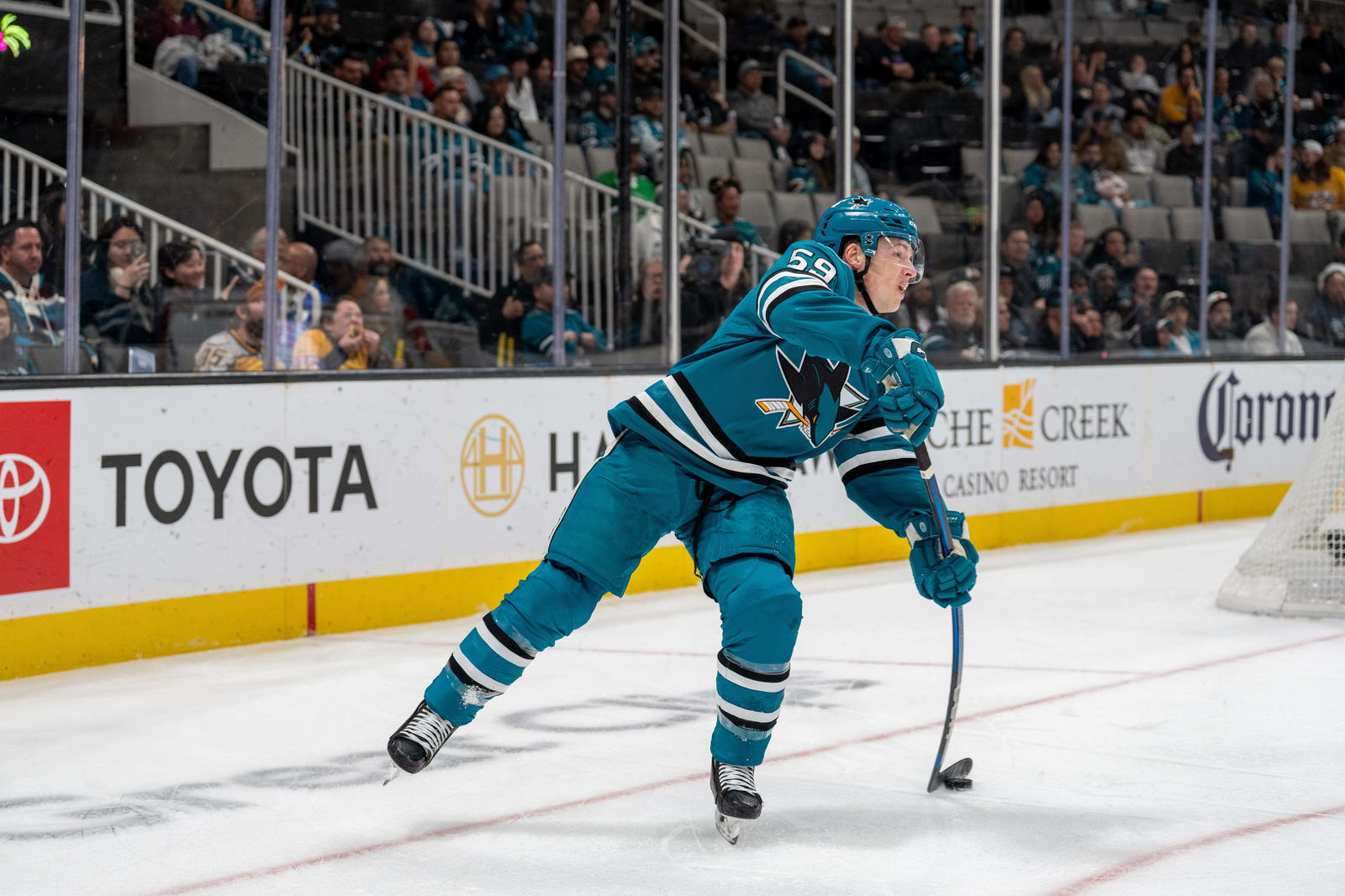 Mar 11, 2025; San Jose, California, USA; San Jose Sharks defenseman Jimmy Schuldt (59) passes the puck during the first period against the Nashville Predators at SAP Center at San Jose. Mandatory Credit: Neville E. Guard-Imagn Images
