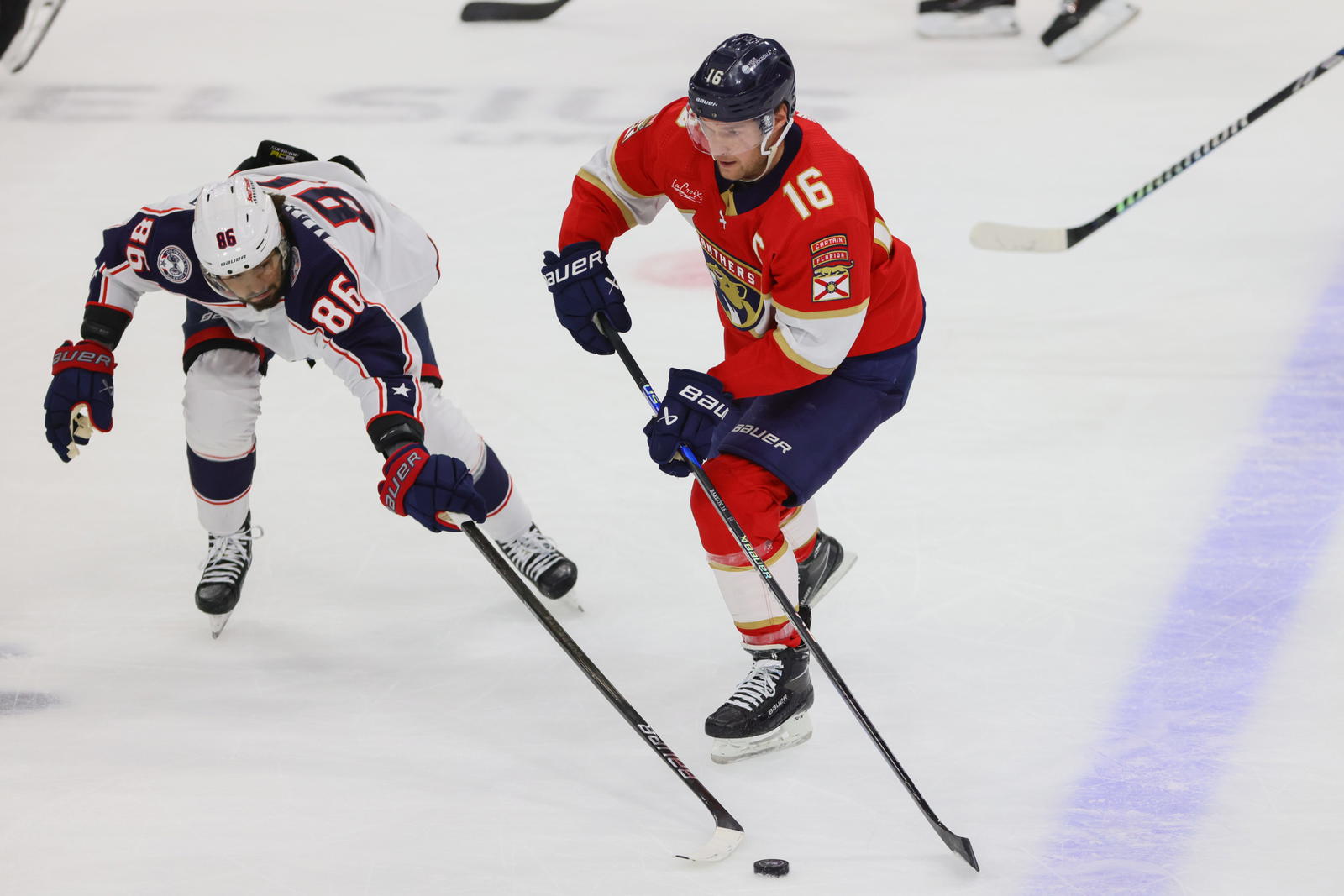 Florida Panthers center Aleksander Barkov (16) moves the puck against Columbus Blue Jackets right wing Kirill Marchenko (86) during the first period at Amerant Bank Arena. (Sam Navarro-Imagn Images)