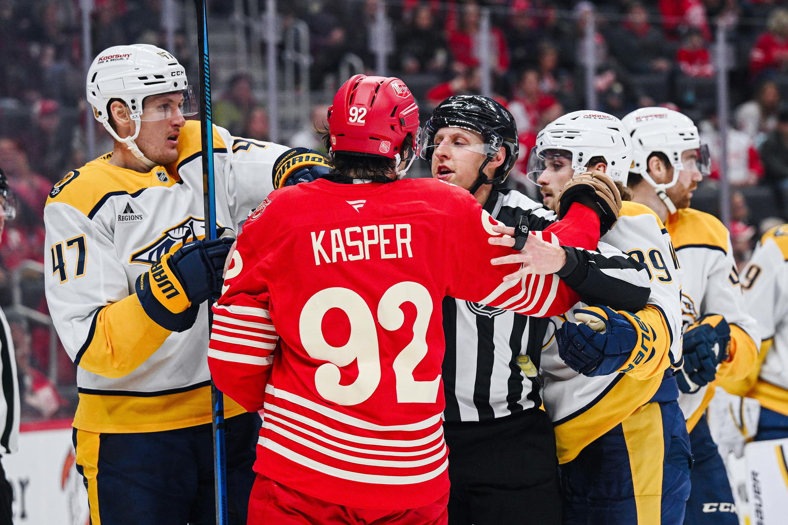 Nov 26, 2025; Detroit, Michigan, USA; Nashville Predators right wing Michael McCarron (47), right wing Ozzy Wiesblatt (89), and Detroit Red Wings center Marco Kasper (92) are broken up during the game at Little Caesars Arena. Tim Fuller-Imagn Images