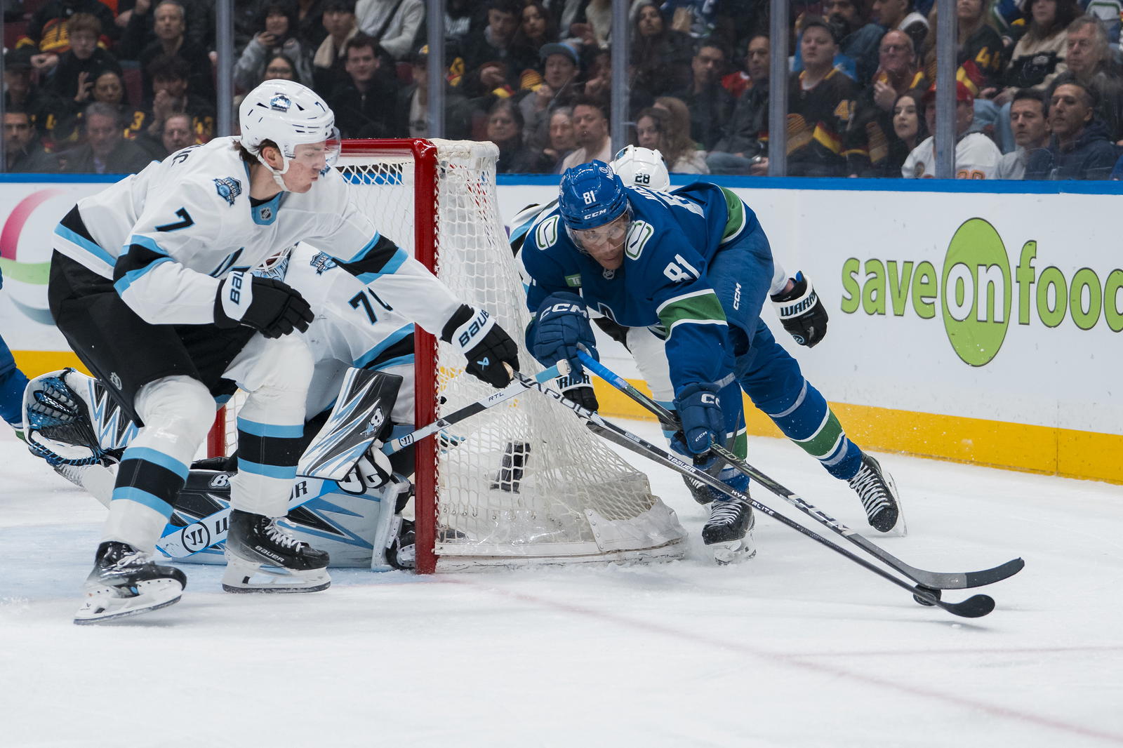 Mar 16, 2025; Vancouver, British Columbia, CAN; Utah Hockey Club defenseman Michael Kesselring (7) stick checks Vancouver Canucks forward Dakota Joshua (81) in the third period at Rogers Arena. Mandatory Credit: Bob Frid-Imagn Images