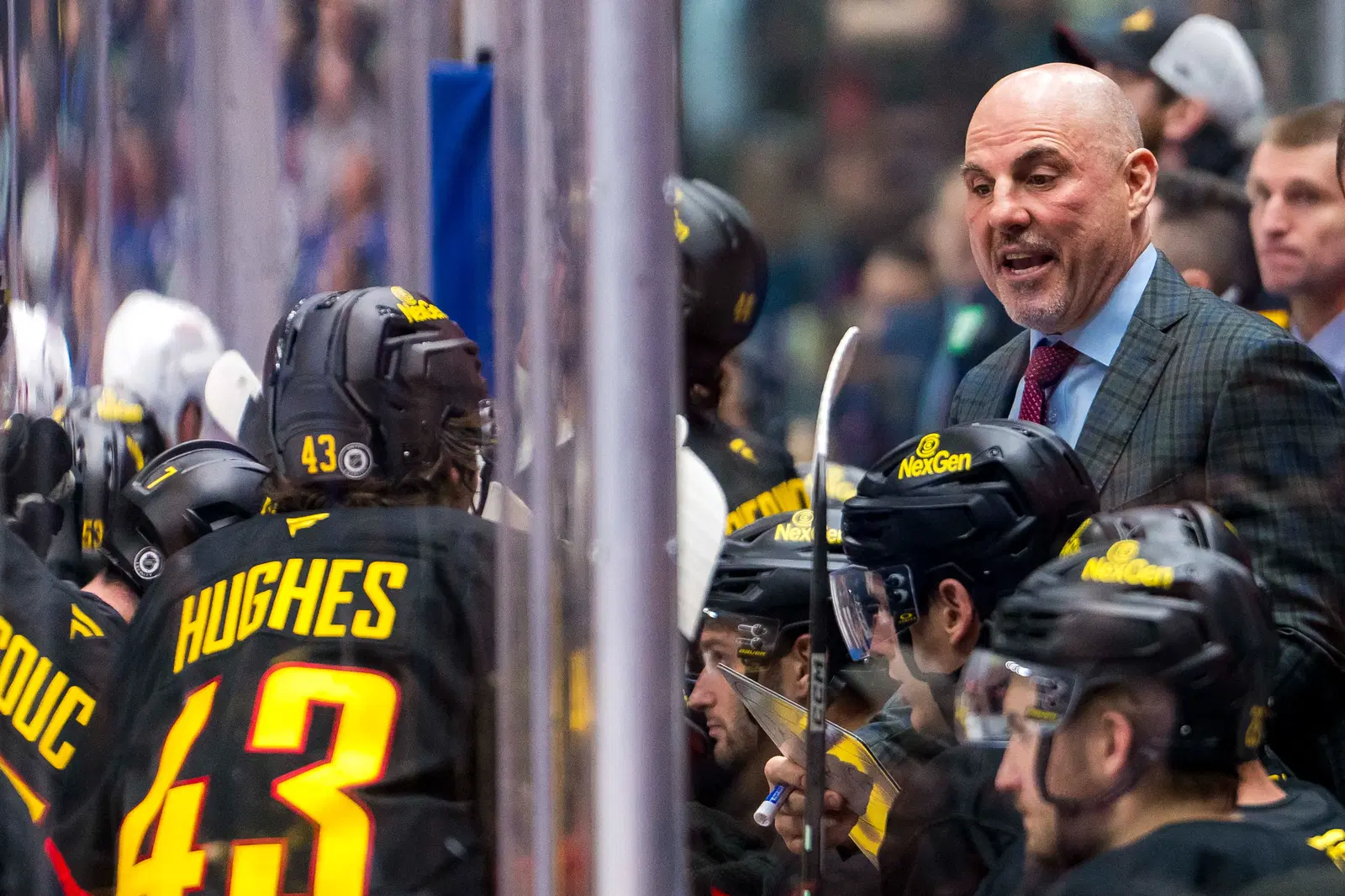 Canucks head coach Rick Tocchet talks with captain Quinn Hughes during a stoppage in play. (Bob Frid, Imagn Images)