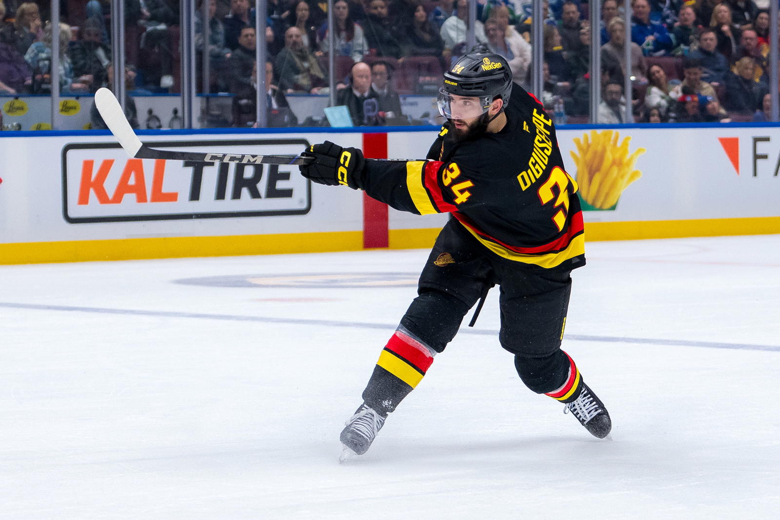Jan 18, 2025; Vancouver, British Columbia, CAN; Vancouver Canucks forward Phillip Di Giuseppe (34) shoots against the Edmonton Oilers in the second period at Rogers Arena. Mandatory Credit: Bob Frid-Imagn Images