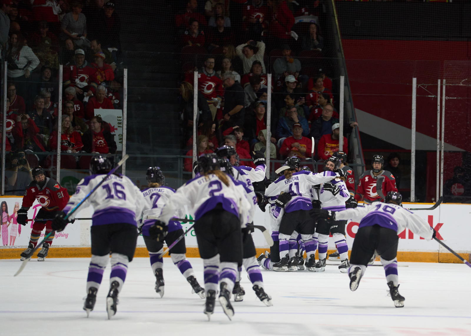 The Minnesota Frost swarm Curl-Salemme to celebrate the team's overtime winner -&nbsp;Photo @ Ellen Bond