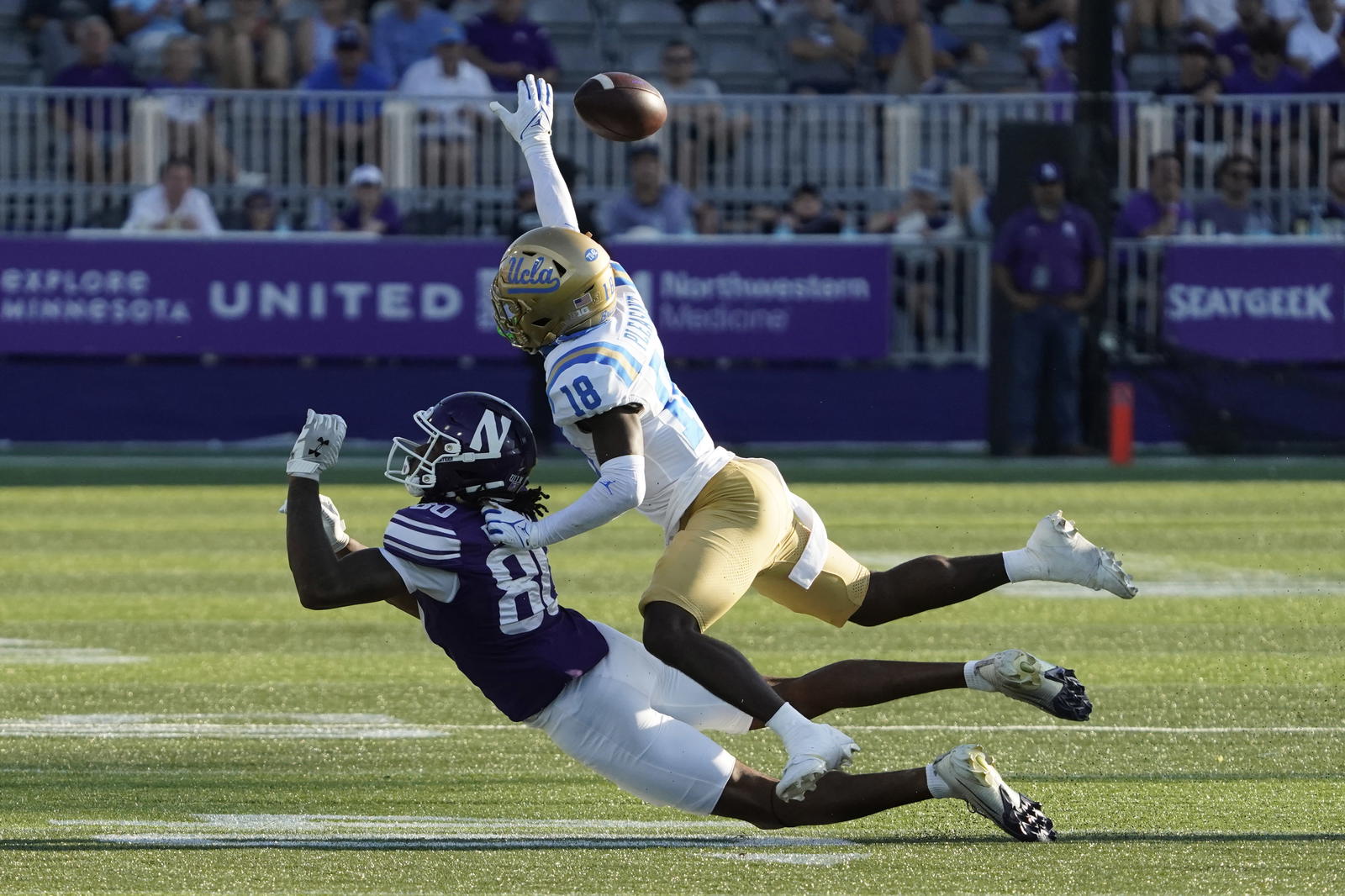Sep 27, 2025; Evanston, Illinois, USA; UCLA Bruins defensive back Rodrick Pleasant (18) defends Northwestern Wildcats wide receiver Hayden Eligon II (80) during the second half at Northwestern Medicine Field at Martin Stadium. Mandatory Credit: David Banks-Imagn Images