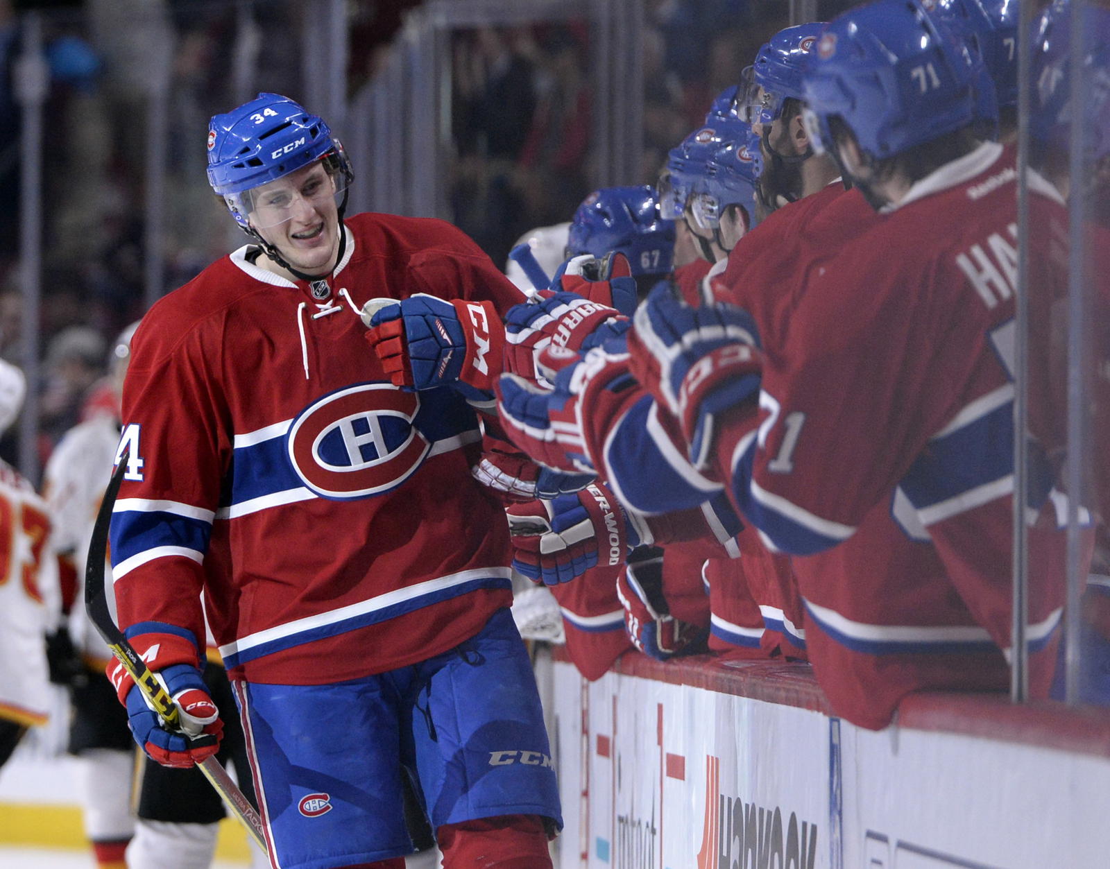 Mar 20, 2016; Montreal, Quebec, CAN; Montreal Canadiens forward Michael McCarron (34) celebrates with teammates after scoring a goal against the Calgary Flames during the third period at the Bell Centre. It was McCarron's first goal scored in the NHL. Mandatory Credit: Eric Bolte-Imagn Images