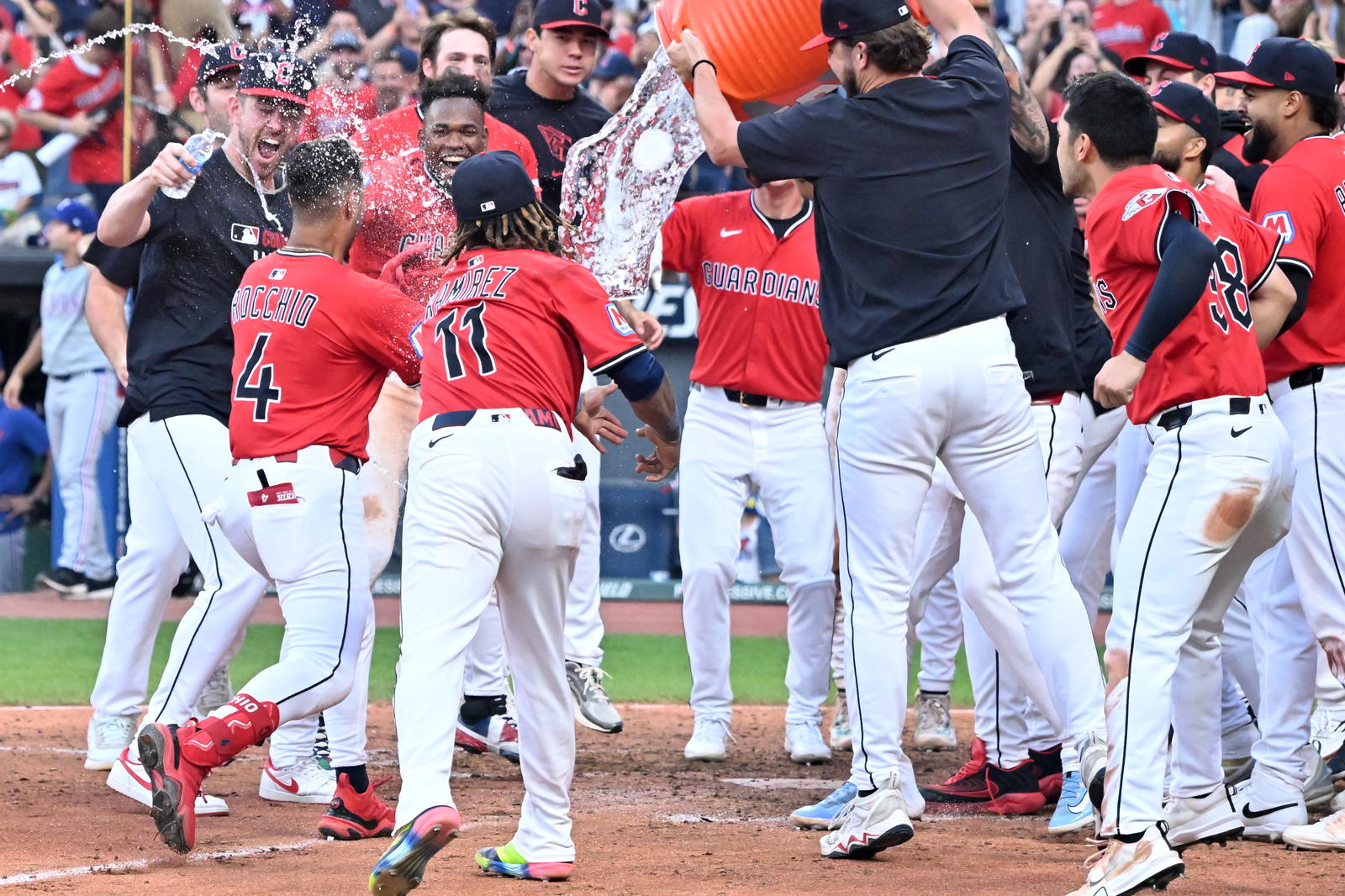 Sep 28, 2025; Cleveland, Ohio, USA; The Cleveland Guardians celebrate as shortstop Brayan Rocchio (4) crosses the plate after hitting a three run home run to win the game in the tenth inning against the Texas Rangers at Progressive Field. Mandatory Credit: Ken Blaze-Imagn Images