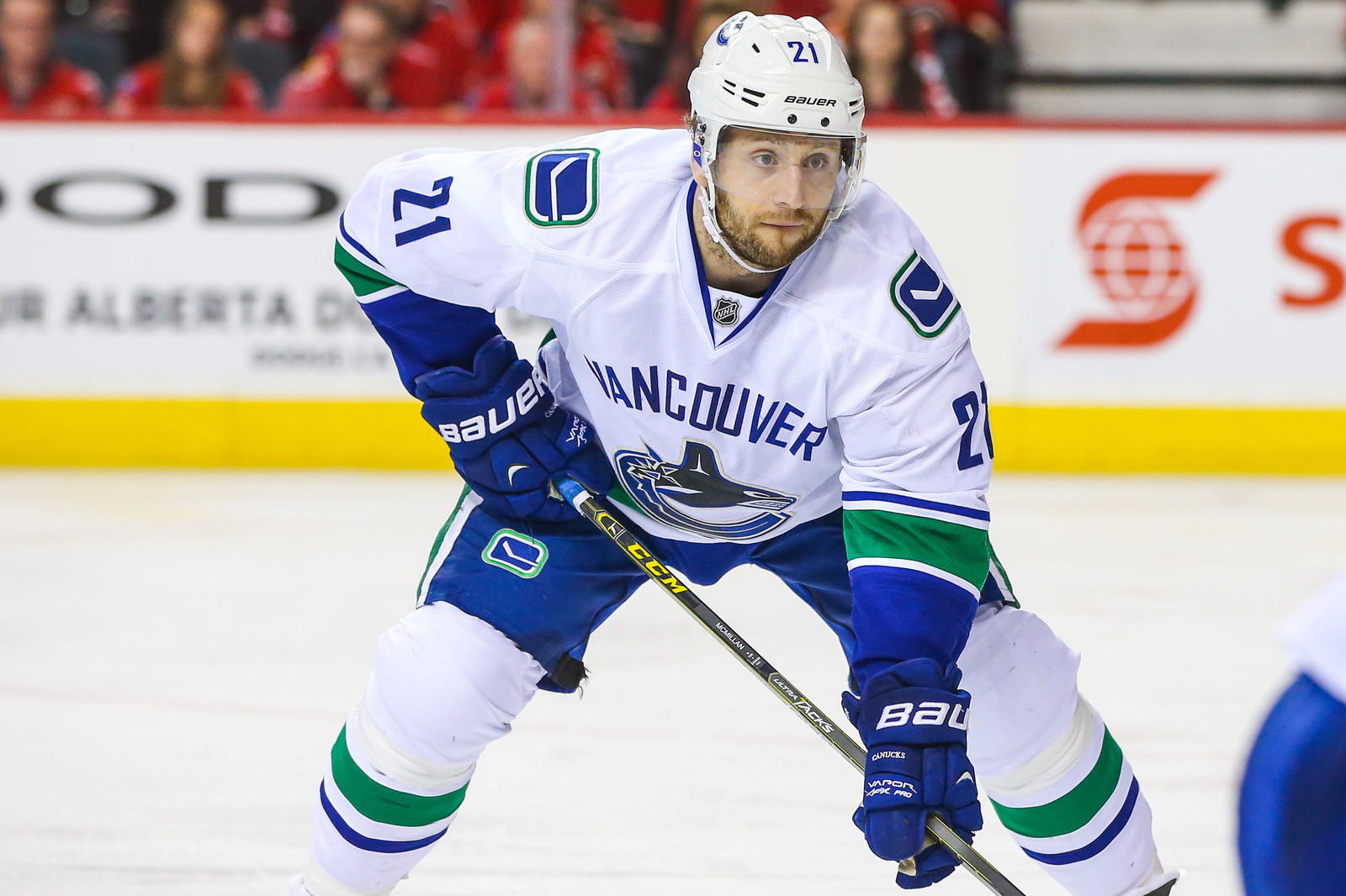 Apr 25, 2015; Calgary, Alberta, CAN; Vancouver Canucks left wing Brandon McMillan (21) during face-off during the second period in game six of the first round of the 2015 Stanley Cup Playoffs against the Calgary Flames at Scotiabank Saddledome. Calgary Flames won 7-4. Mandatory Credit: Sergei Belski-Imagn Images